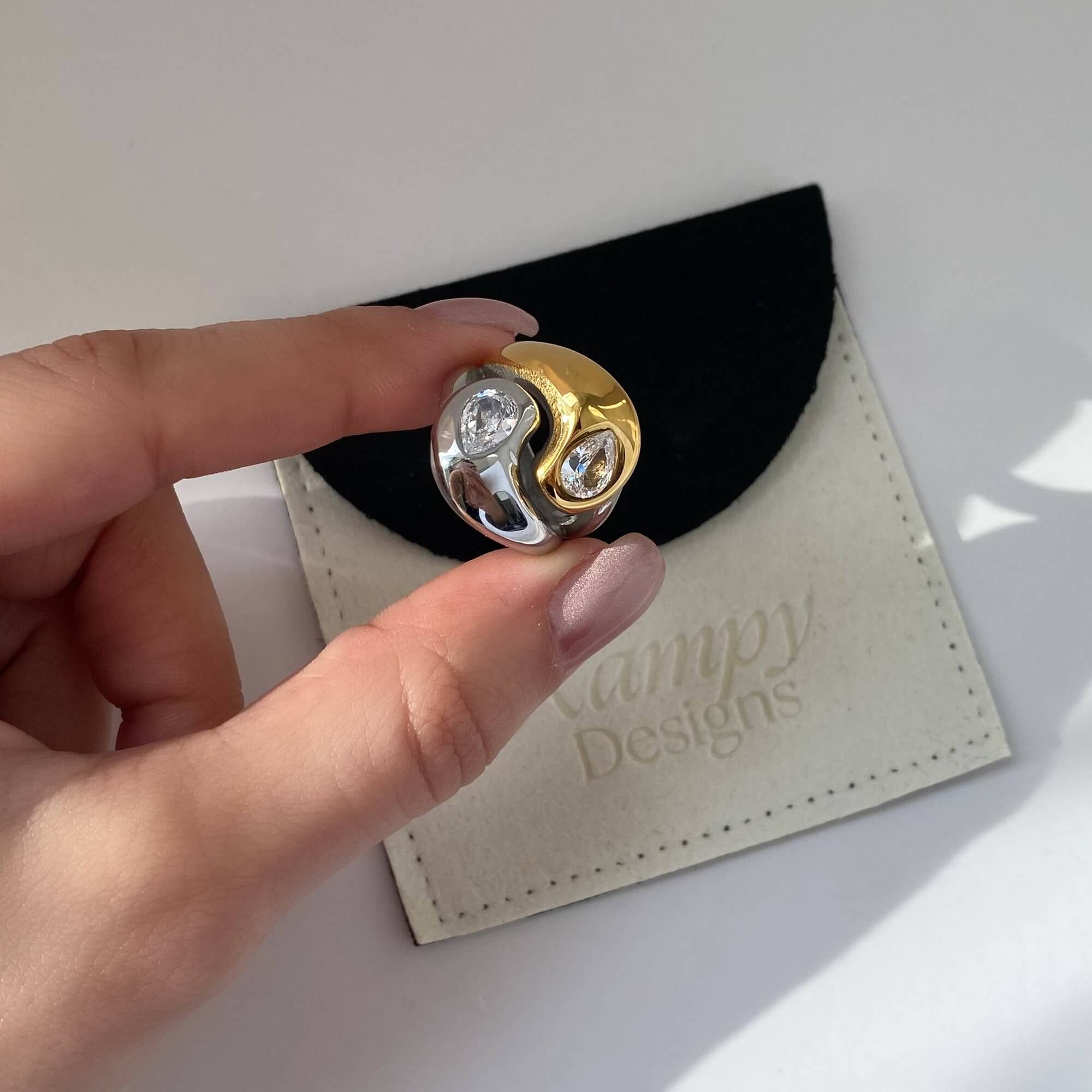 Close-up of the KangR two-toned yin yang ring by Kampy Designs, highlighting its black-and-gold split design and glossy surface.