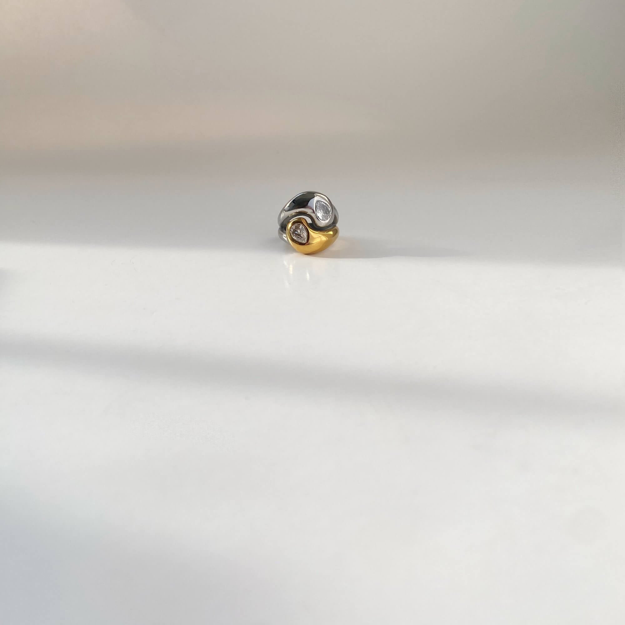 Flat lay of the KangR two-toned yin yang ring by Kampy Designs, elegantly displayed to reflect its contemporary design and spiritual symbolism.