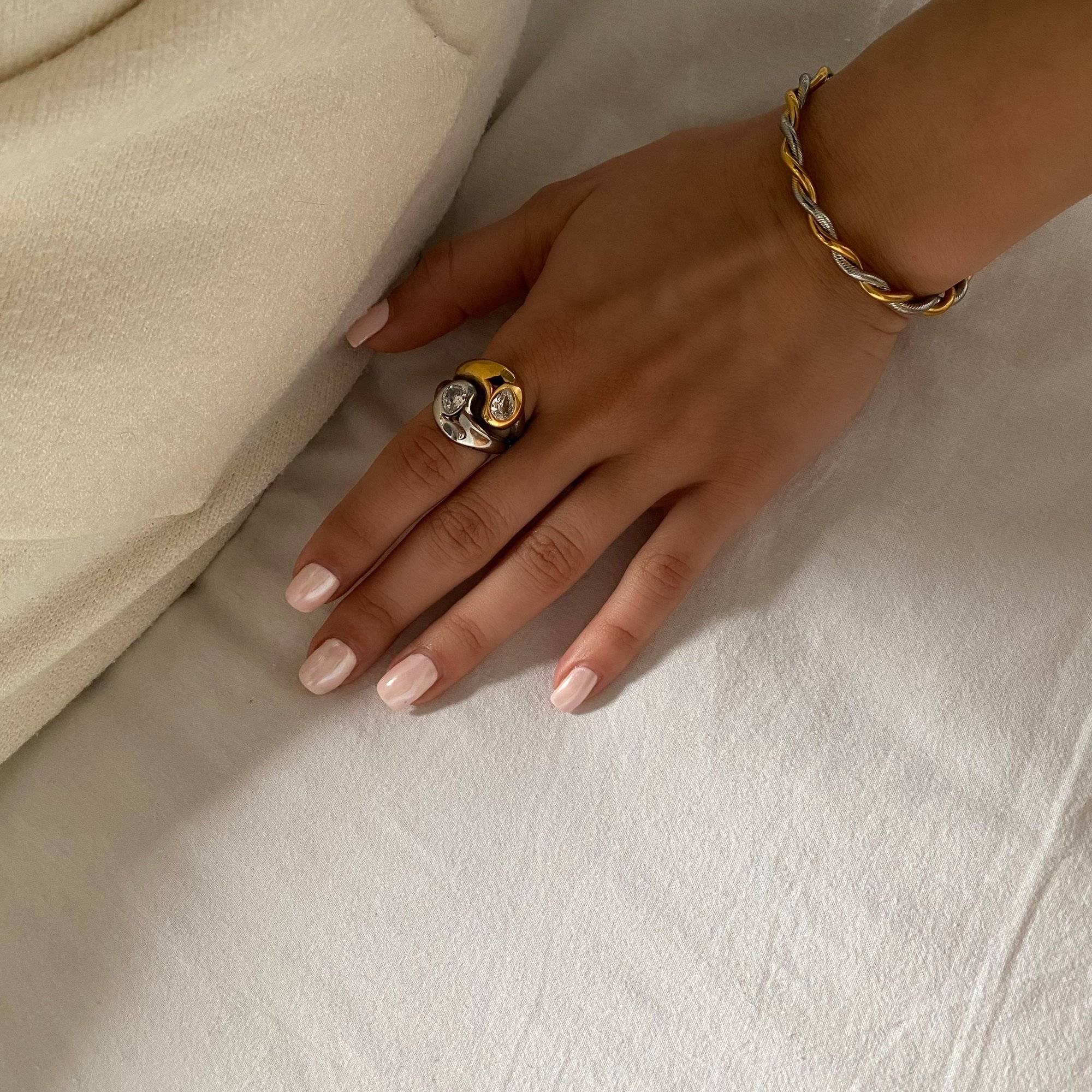 Close-up styled image of KangR two-toned yin yang ring by Kampy Designs, focusing on the intricate detail of the symbolic centerpiece.