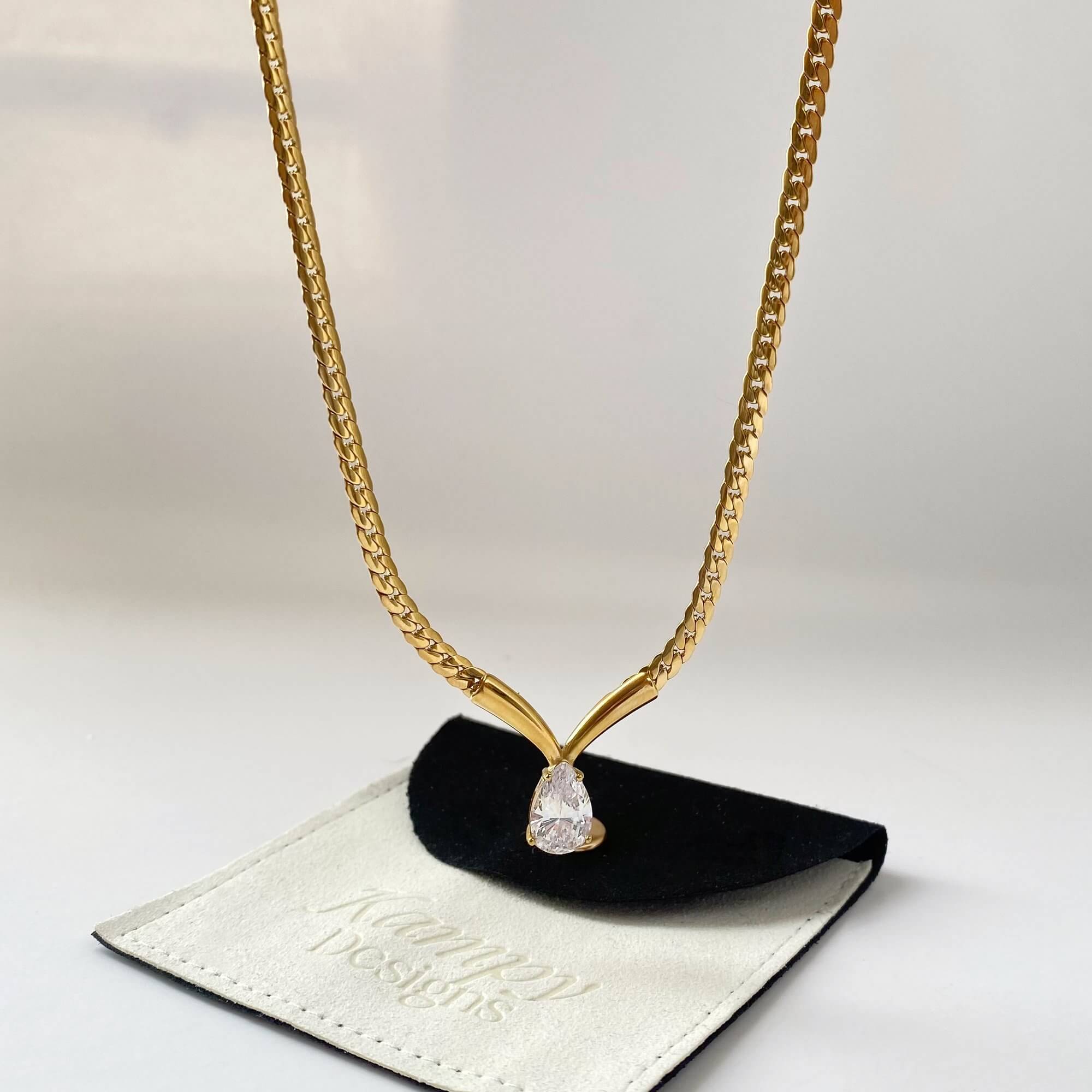 Dangle view of the Kaliyan V-chain necklace with pear-shaped diamond by Kampy Designs, capturing the pendant’s graceful drop and delicate chain.
