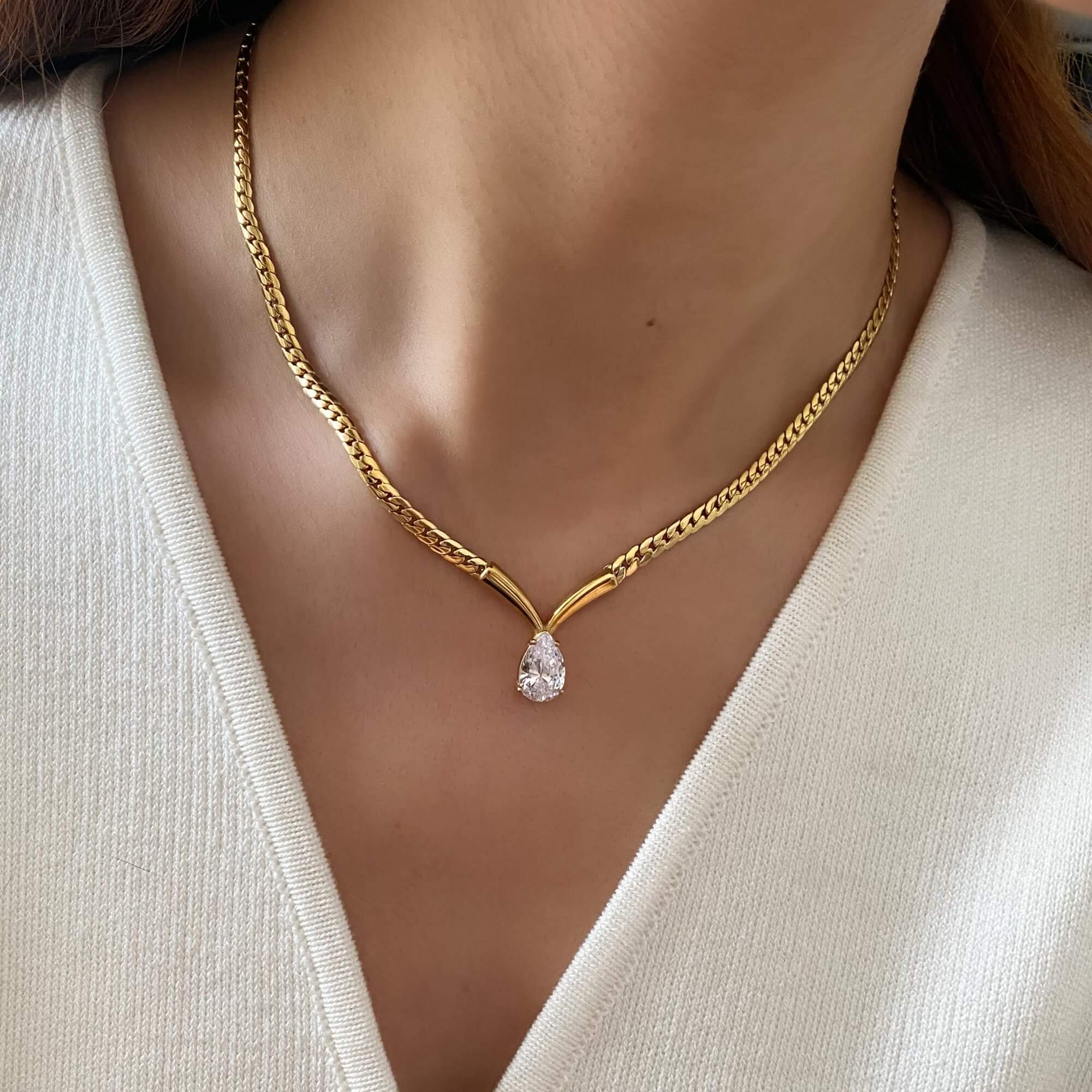 The Kaliyan V-chain necklace by Kampy Designs, modeled with an elegant outfit to reflect modern minimalism and everyday luxury.