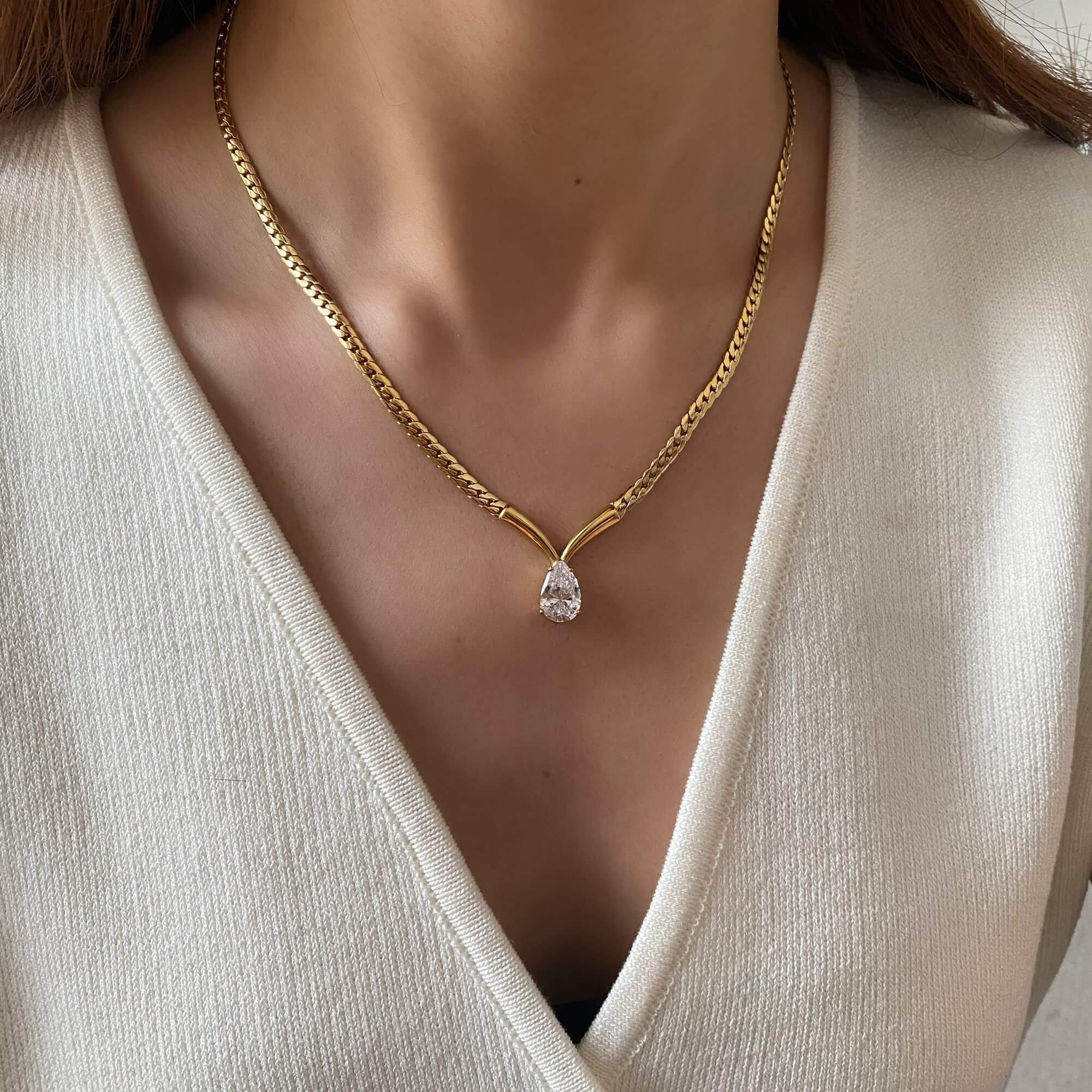 Side angle of the Kaliyan V-chain necklace with pear diamond by Kampy Designs, elegantly resting along the collarbone for a graceful profile.
