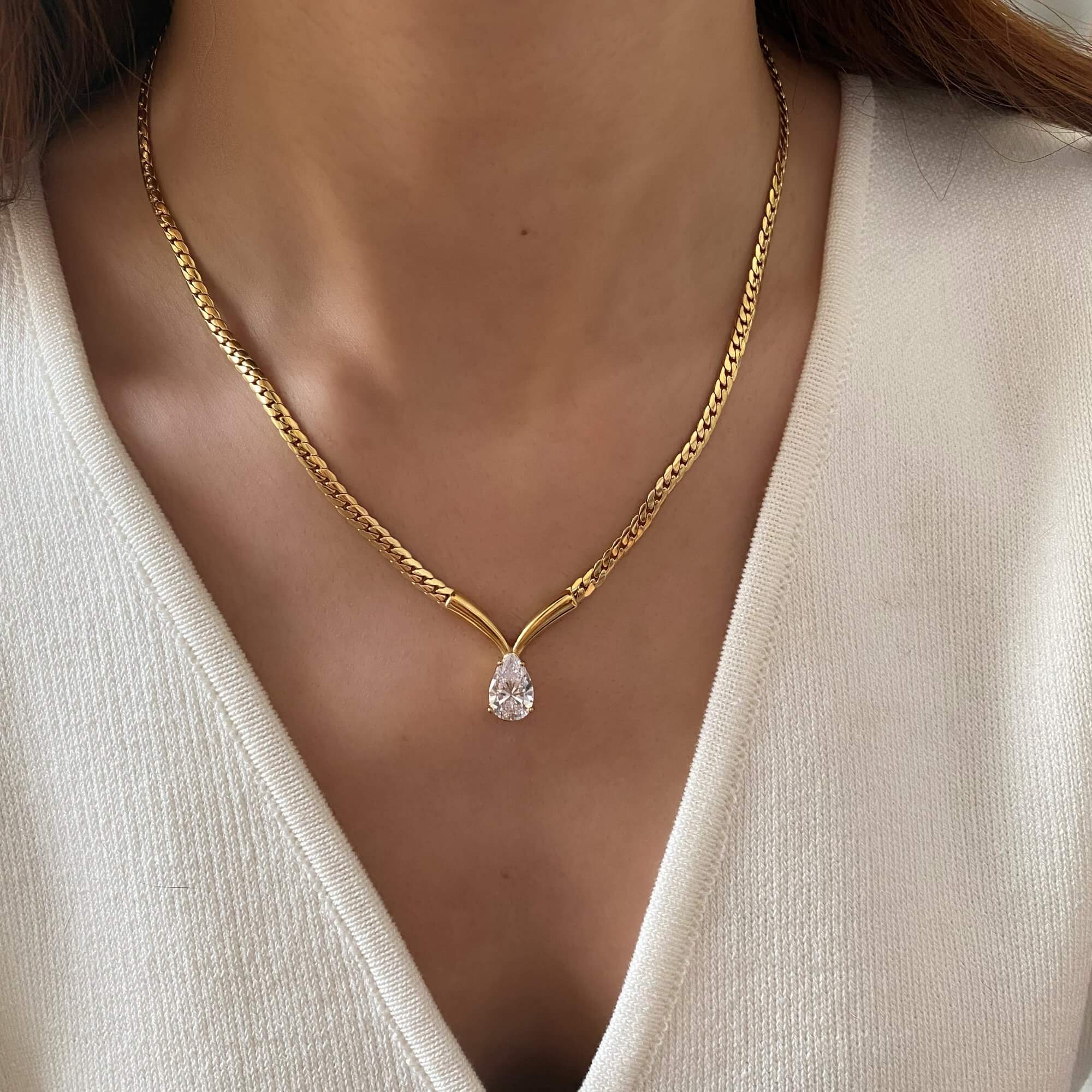 he Kaliyan V-chain necklace with pear-shaped diamond by Kampy Designs, styled on model to showcase its refined V silhouette and elegant sparkle