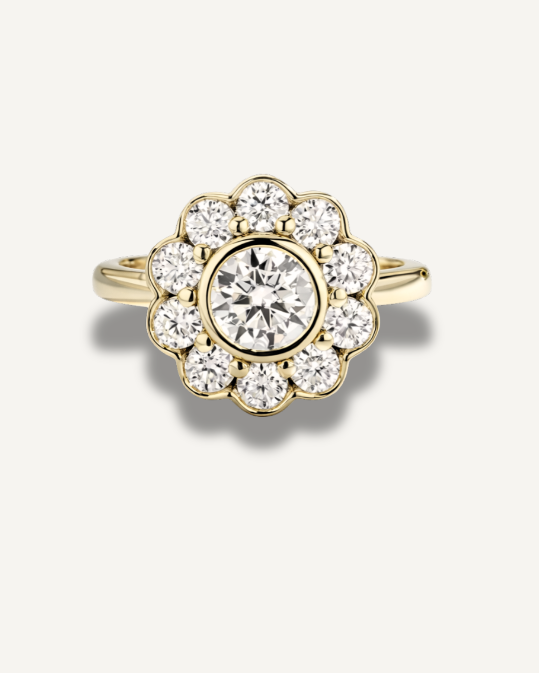 The Marigold Ring by Kampy Designs shown in gold, featuring a 1ct round moissanite with ten 3mm halo stones in a vintage floral bezel setting on a neutral background.