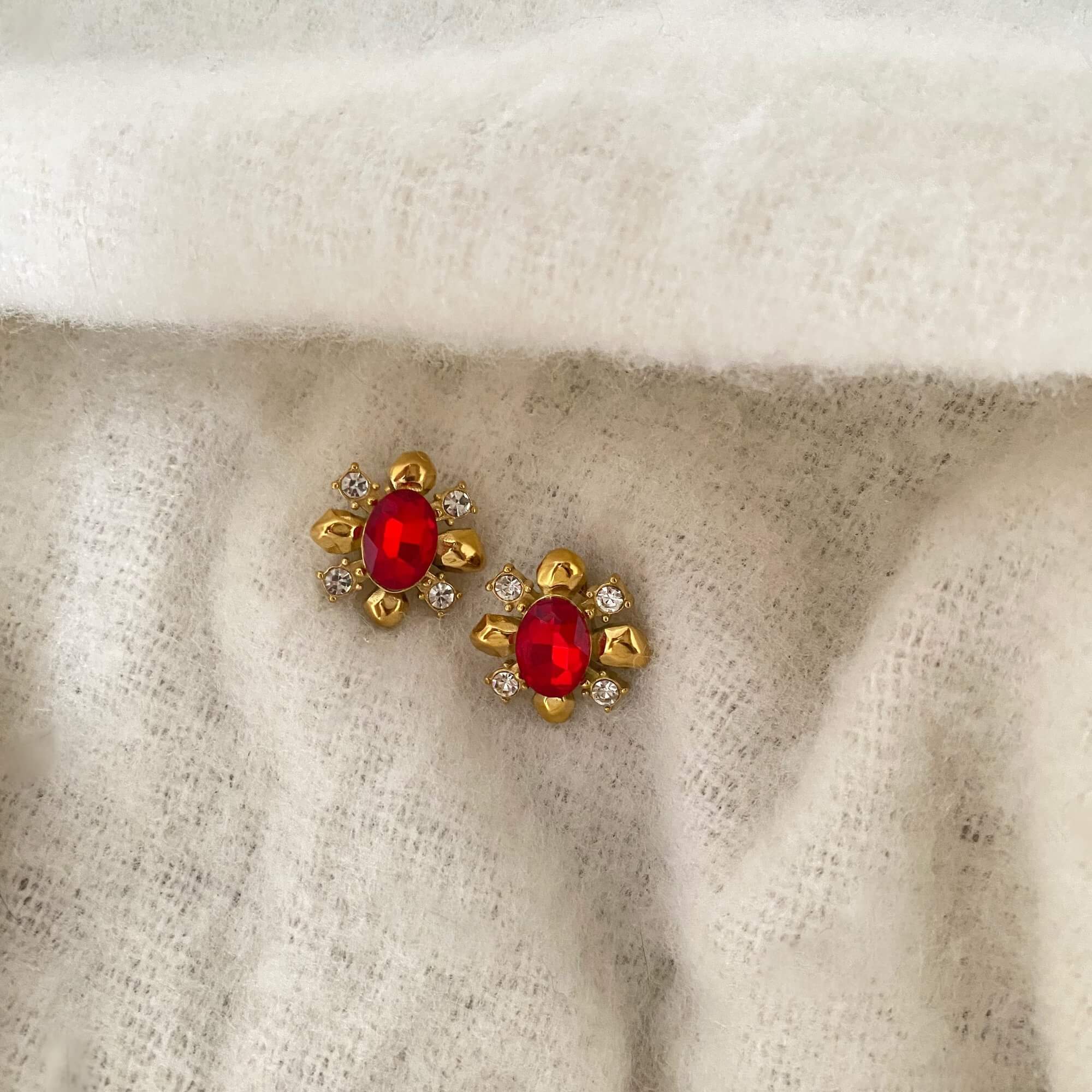 Front view of the KarnaraE vintage garnet stud earrings by Kampy Designs, showcasing their round-cut garnet stones set in a classic gold frame.