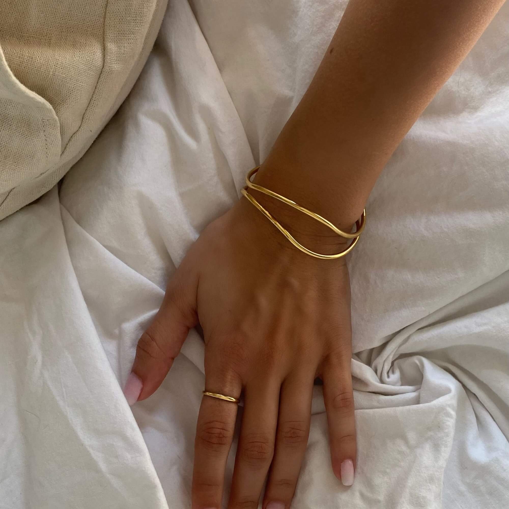 Side view of the KohoB wave cuff bracelet by Kampy Designs, showcasing its fluid curves and elegant wave-inspired design.