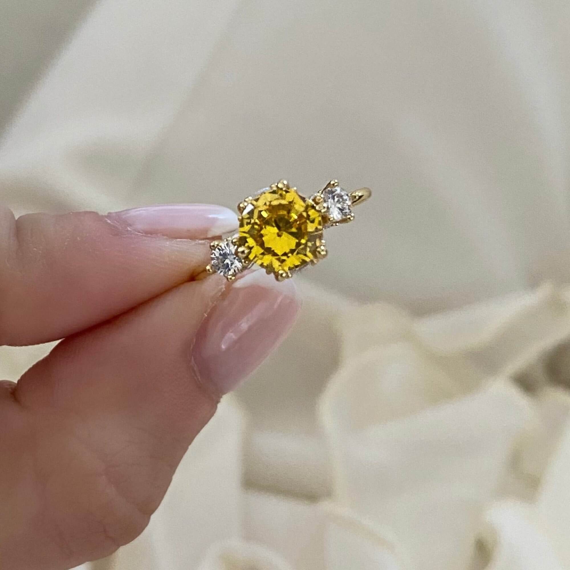 Front view of the KiahR yellow round solitaire ring by Kampy Designs, featuring a vibrant yellow gemstone in a classic solitaire setting.