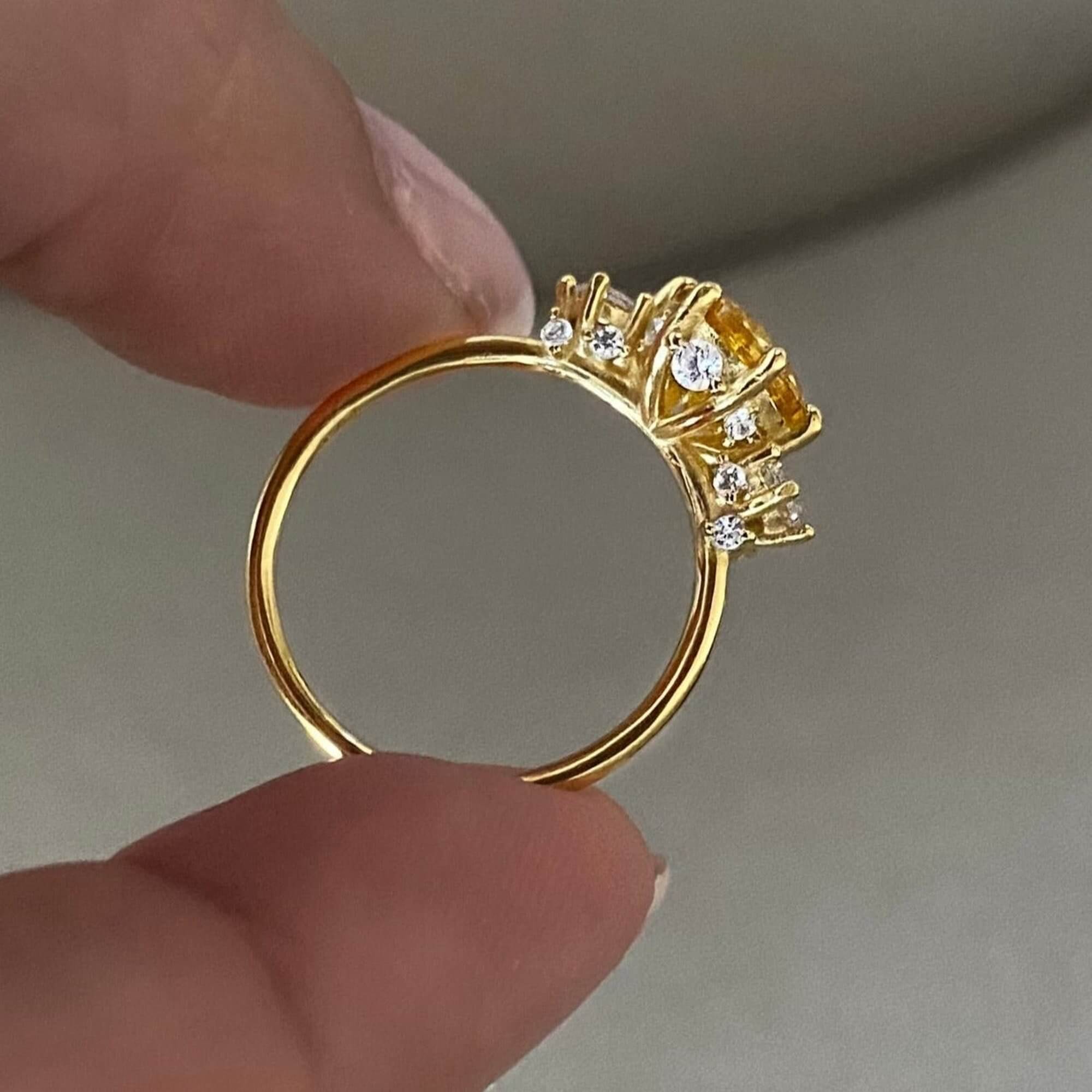 Side view of the KiahR yellow round solitaire ring by Kampy Designs, showcasing its sleek gold band and elegantly set round gemstone.