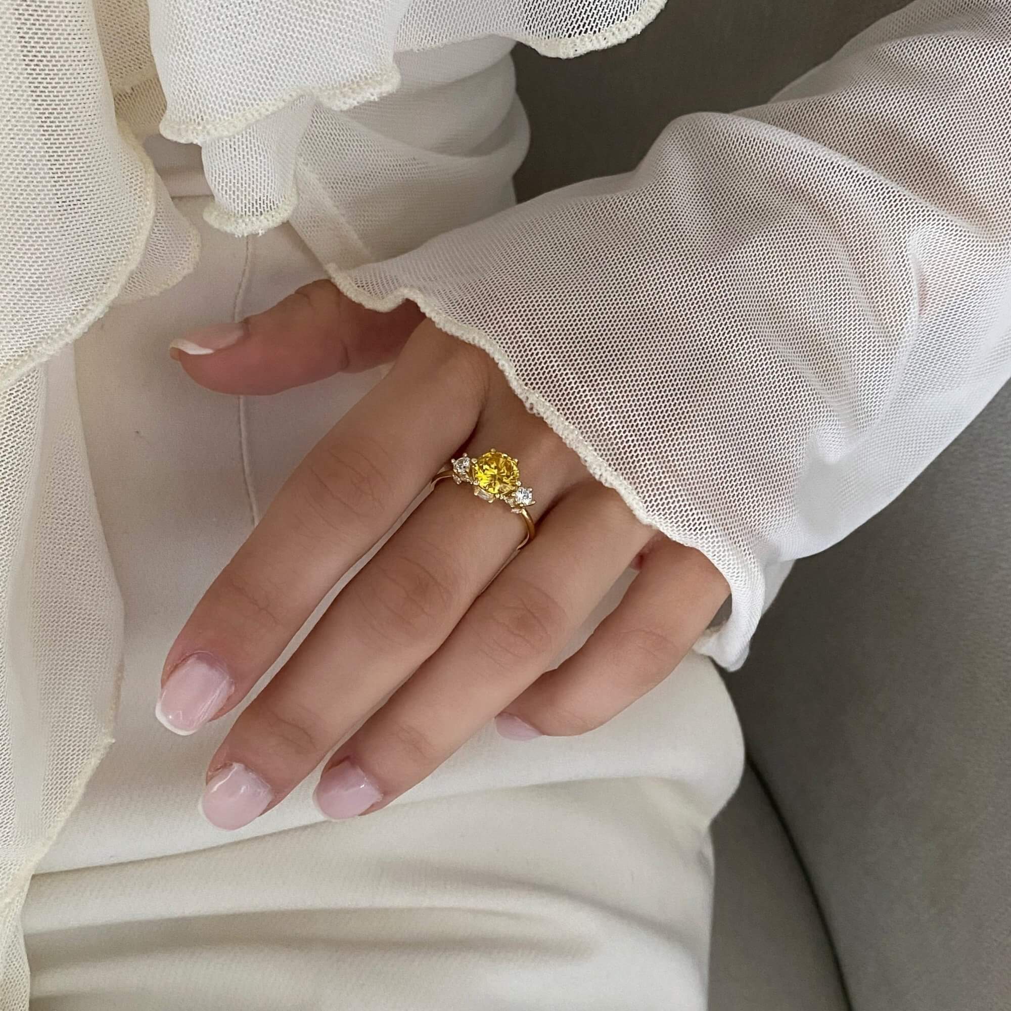 The KiahR yellow round solitaire ring by Kampy Designs, beautifully worn to showcase its elegant and timeless design.