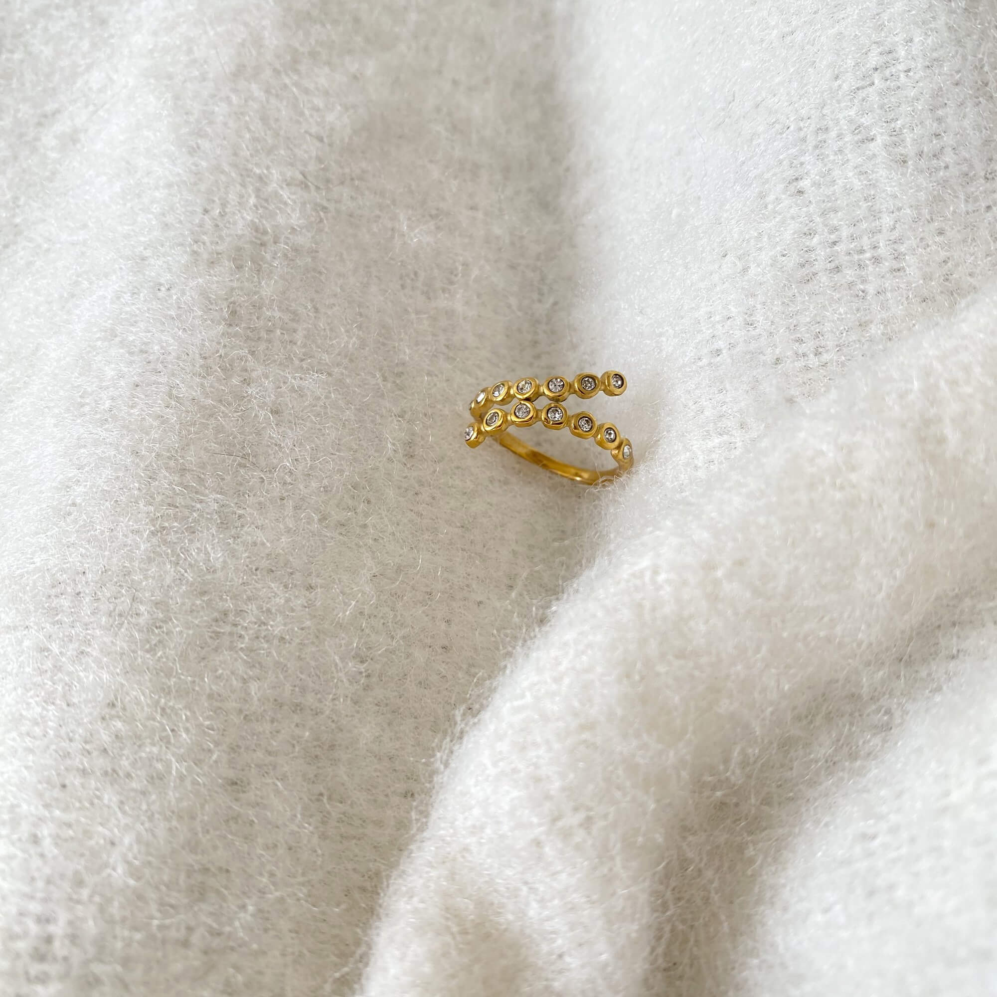 Front view of the KazzyR zircon bezel wrap ring by Kampy Designs, featuring the ring’s sleek profile and perfectly centered stone.