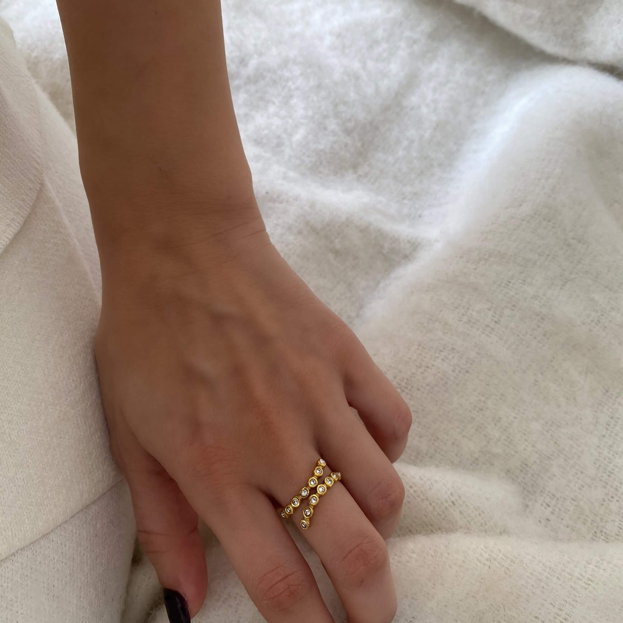 Side view of the KazzyR zircon bezel wrap ring by Kampy Designs, revealing its curved band and flush-fit bezel stone.