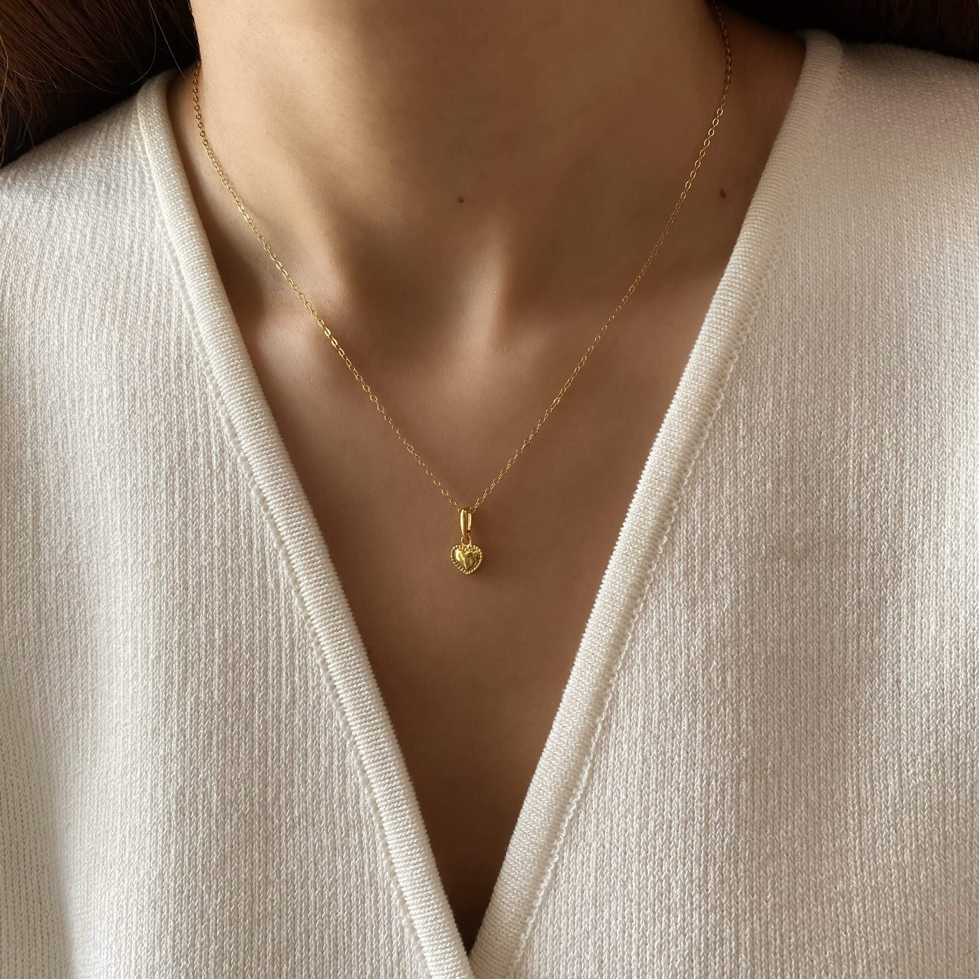 Alternative worn view of the KahiraN 14K gold-plated tiny heart pendant necklace by Kampy Designs, capturing its subtle elegance and fine craftsmanship.