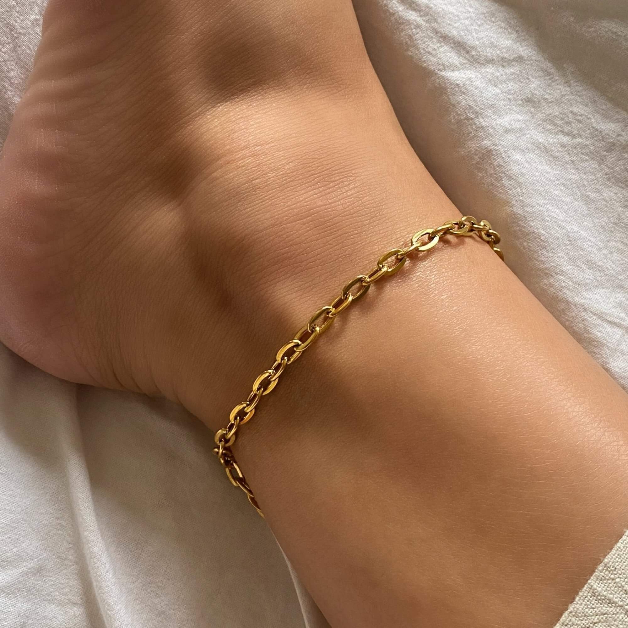 The KayeA 18K gold-plated link chain anklet by Kampy Designs, elegantly worn to highlight its delicate and stylish chain design.