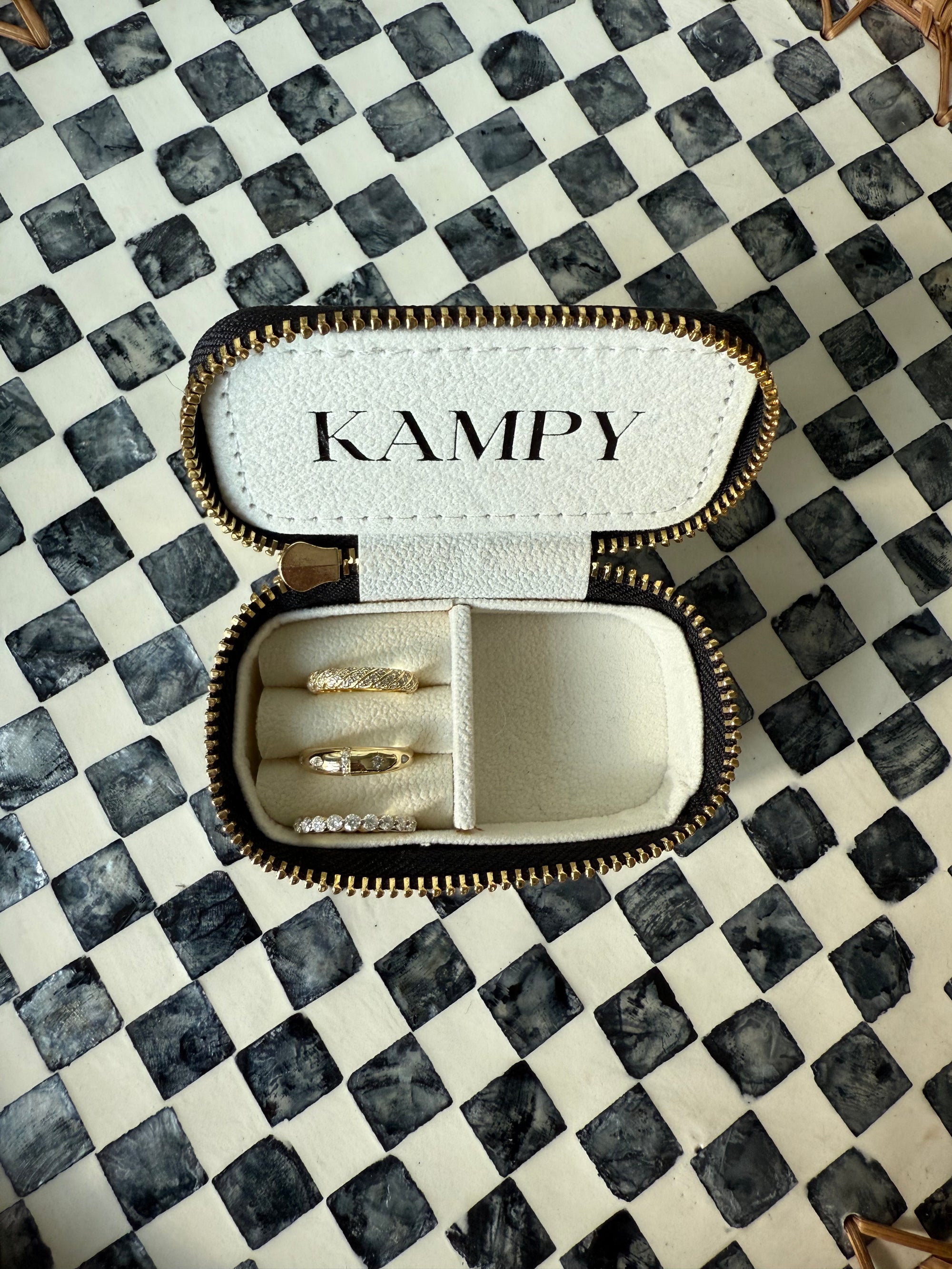 KAMPY jewelry box with rings on a checkered surface