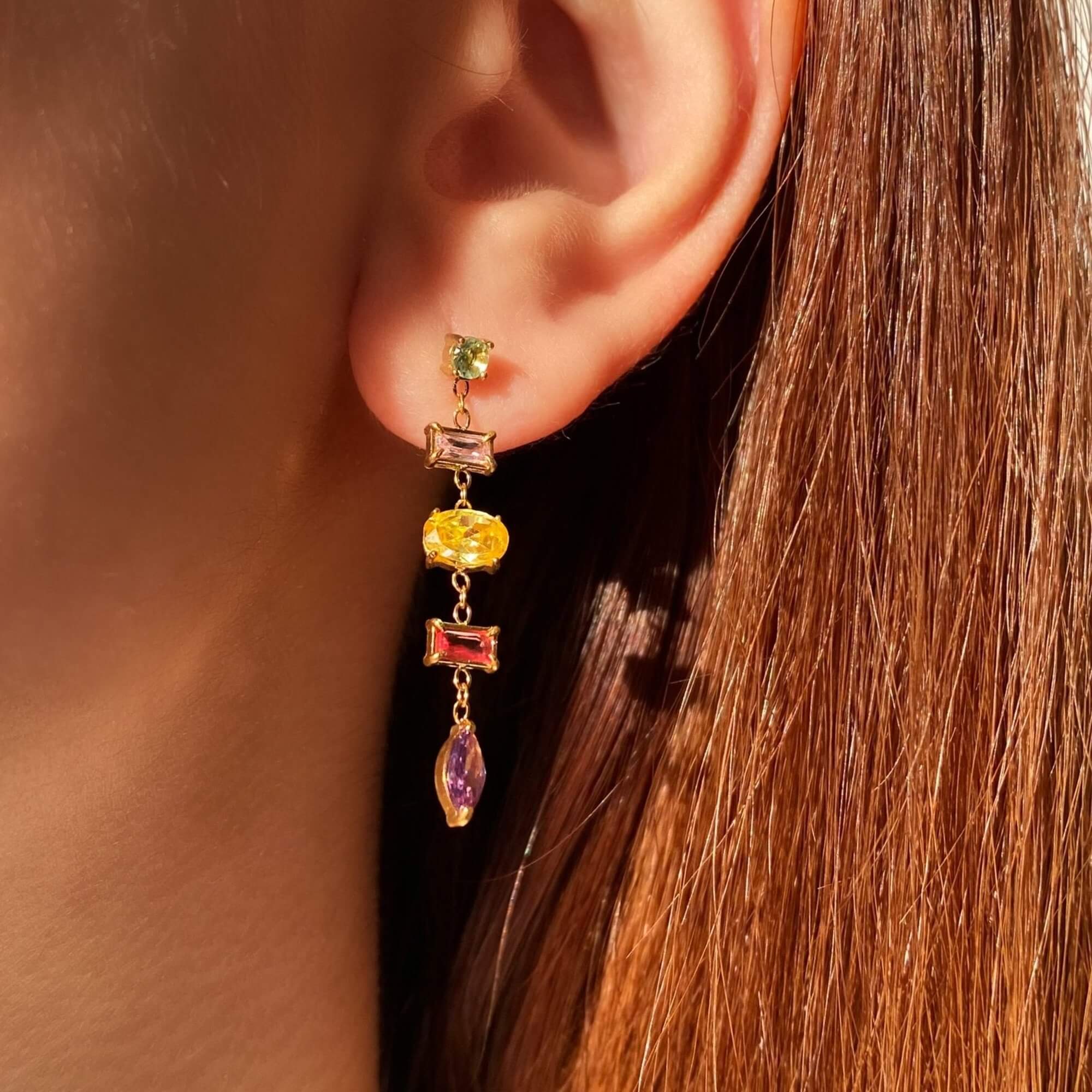 Close-up of the KleoE CZ gemstone dangle earrings by Kampy Designs, highlighting their intricate setting and shimmering cubic zirconia stones.