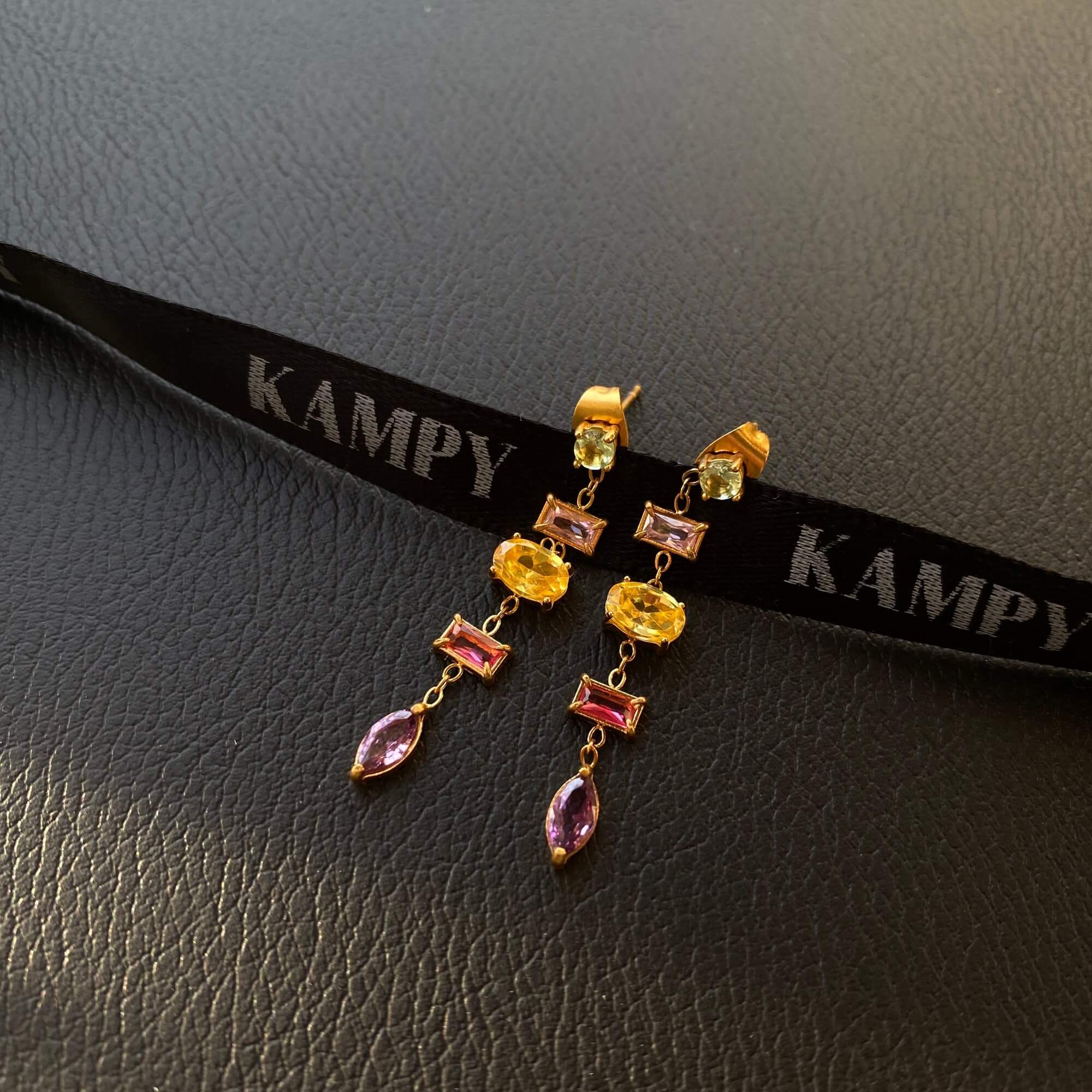 Side view of the KleoE CZ gemstone dangle earrings by Kampy Designs, capturing their delicate structure and luxurious shine.