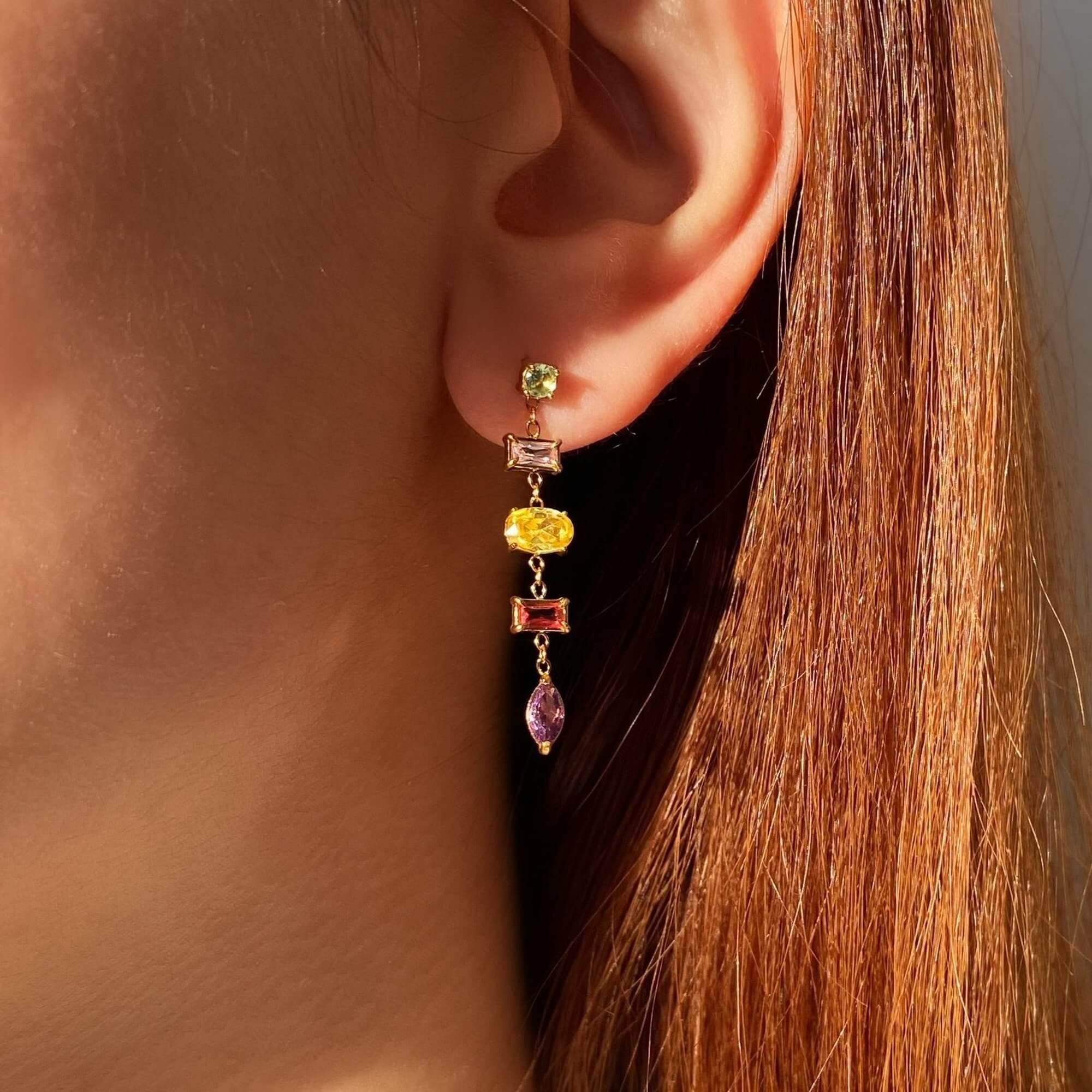 The KleoE CZ gemstone dangle earrings by Kampy Designs, beautifully worn to showcase their sparkling gemstones and elegant drop design.