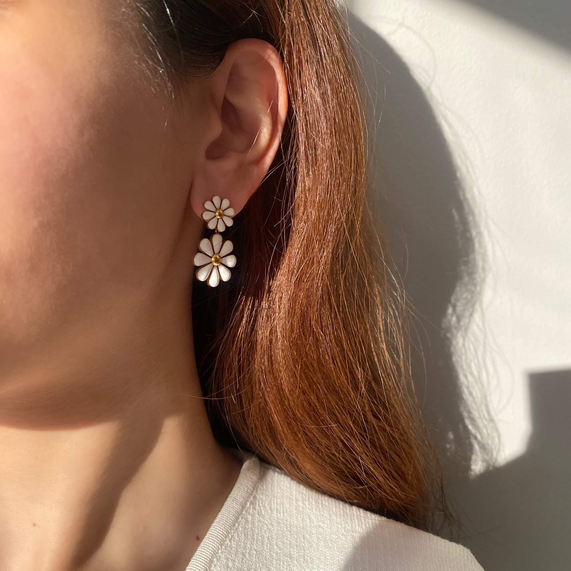 Far shot of KendyR daisy drop earrings by Kampy Designs, showing how the floral motif gently frames the face with elegance.