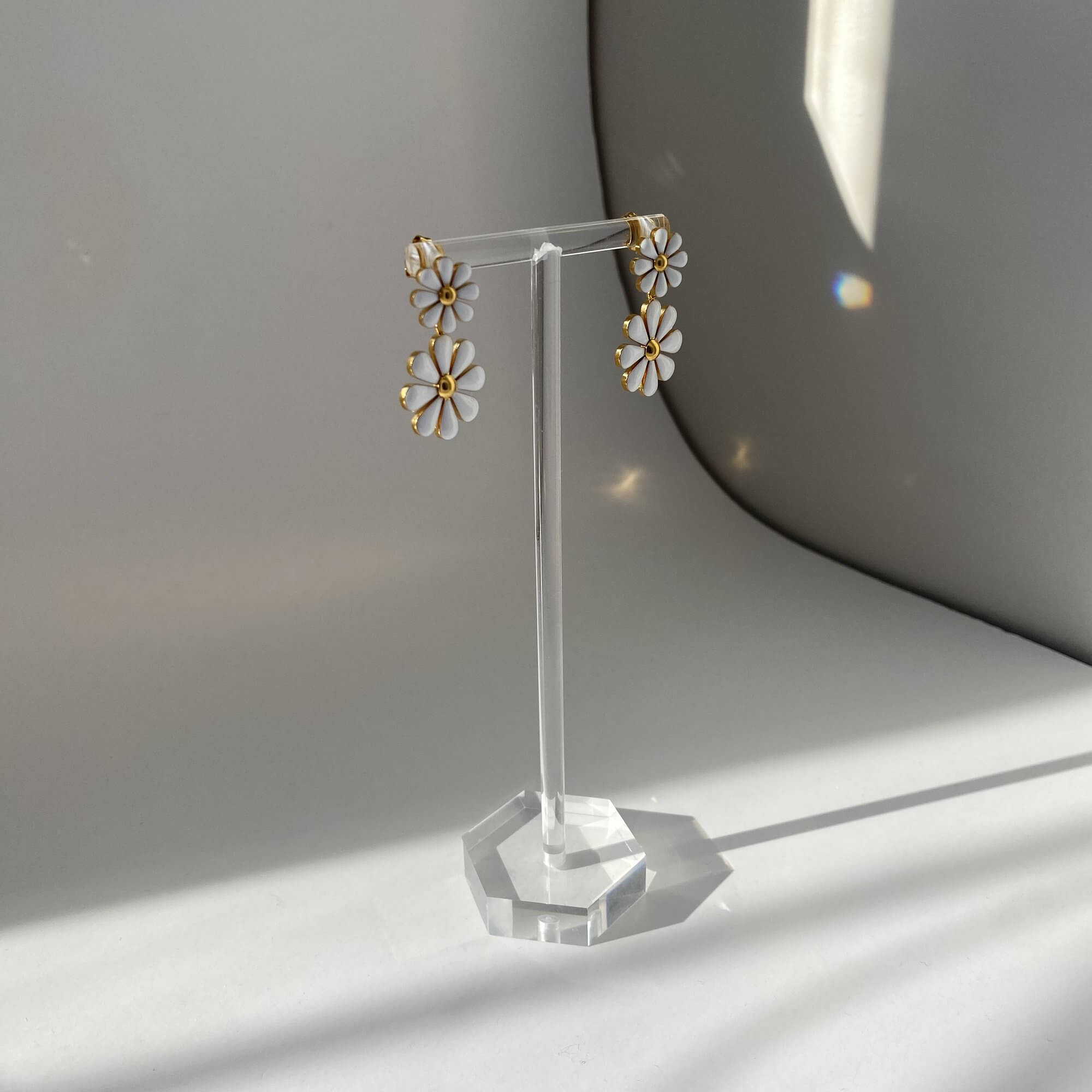 Angled view of KendyR daisy drop earrings by Kampy Designs, capturing the dimensional structure of each floral dangle.