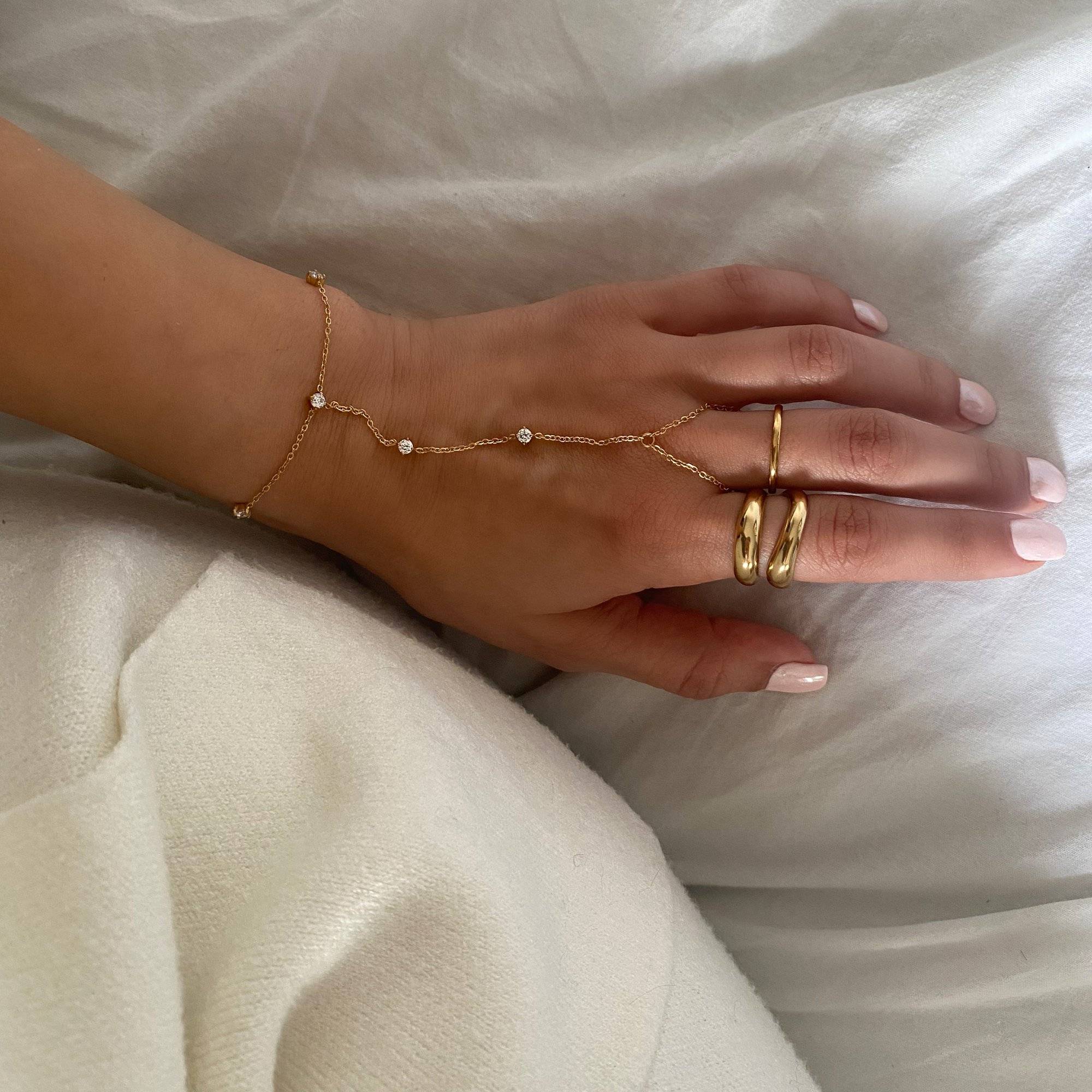 Flat lay of KetsiyaB diamond hand chain bracelet by Kampy Designs, displaying the full structure from finger loop to bracelet clasp.