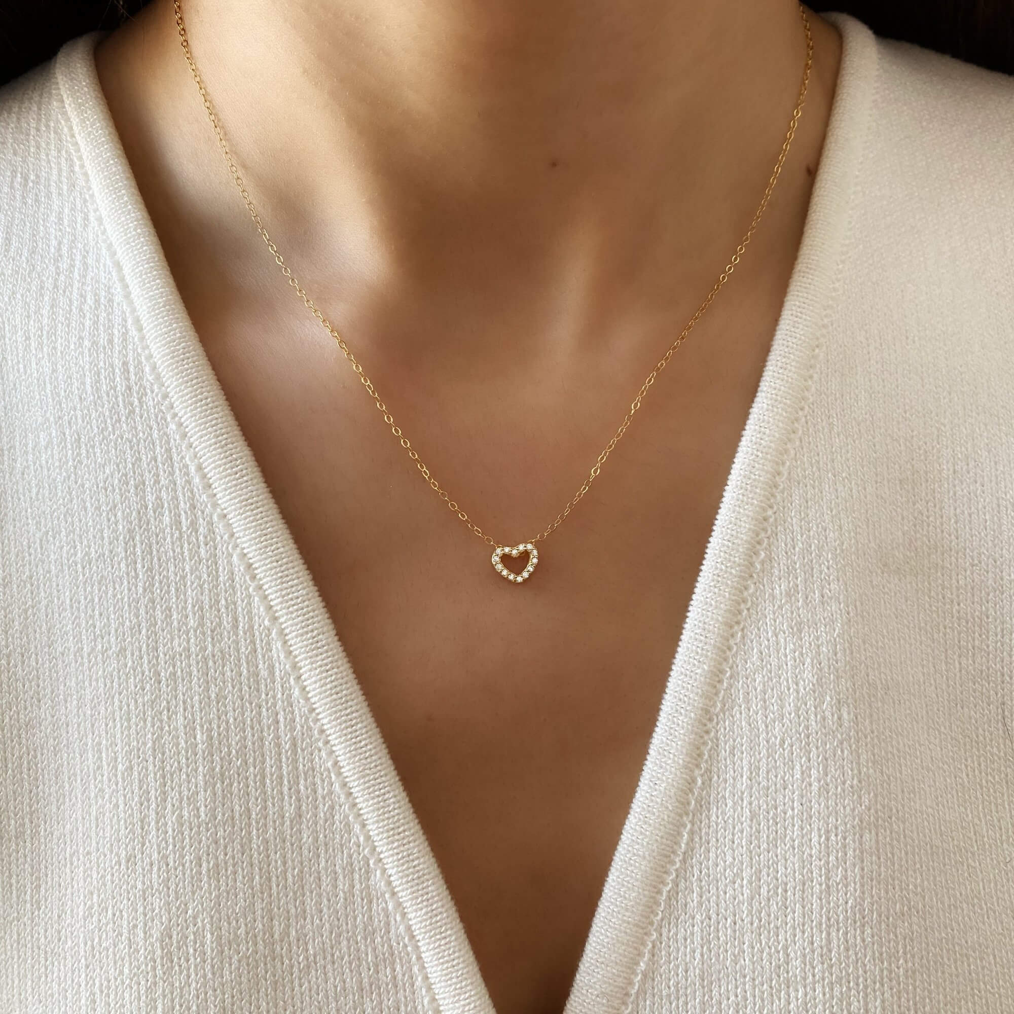 Close-up of the KaseyN diamond hollow heart pendant necklace by Kampy Designs, worn on a model, displaying its luxurious sparkle and refined craftsmanship.