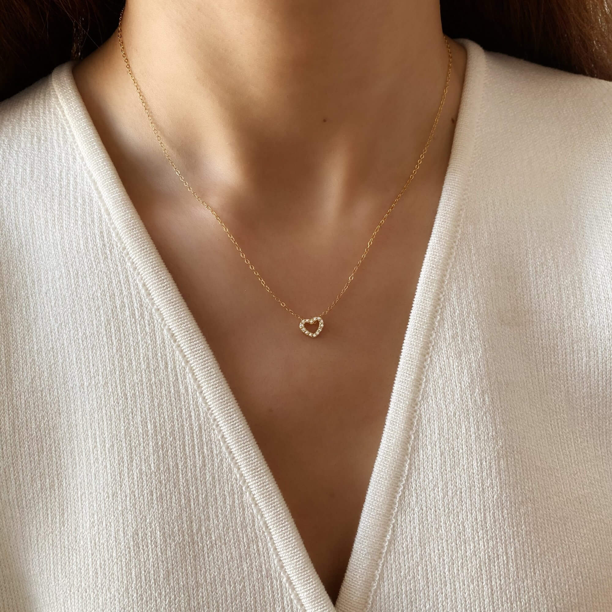 The KaseyN diamond hollow heart pendant necklace by Kampy Designs, elegantly worn, showcasing its timeless heart-shaped design and brilliant diamond details.