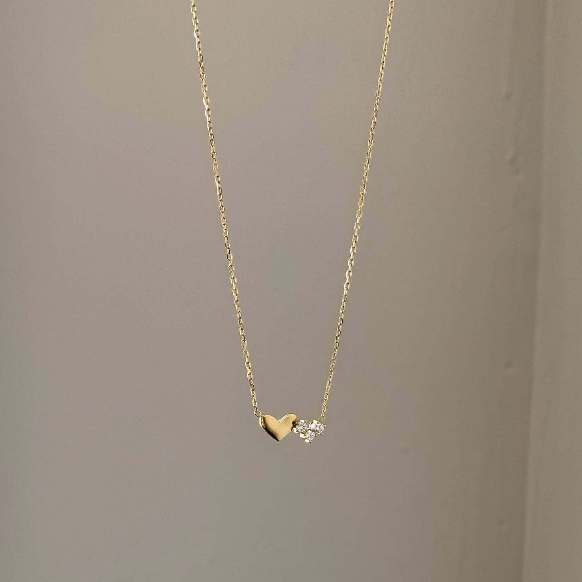 Front view of the KassyN double heart charm necklace by Kampy Designs, featuring two elegant heart charms on a delicate gold chain.