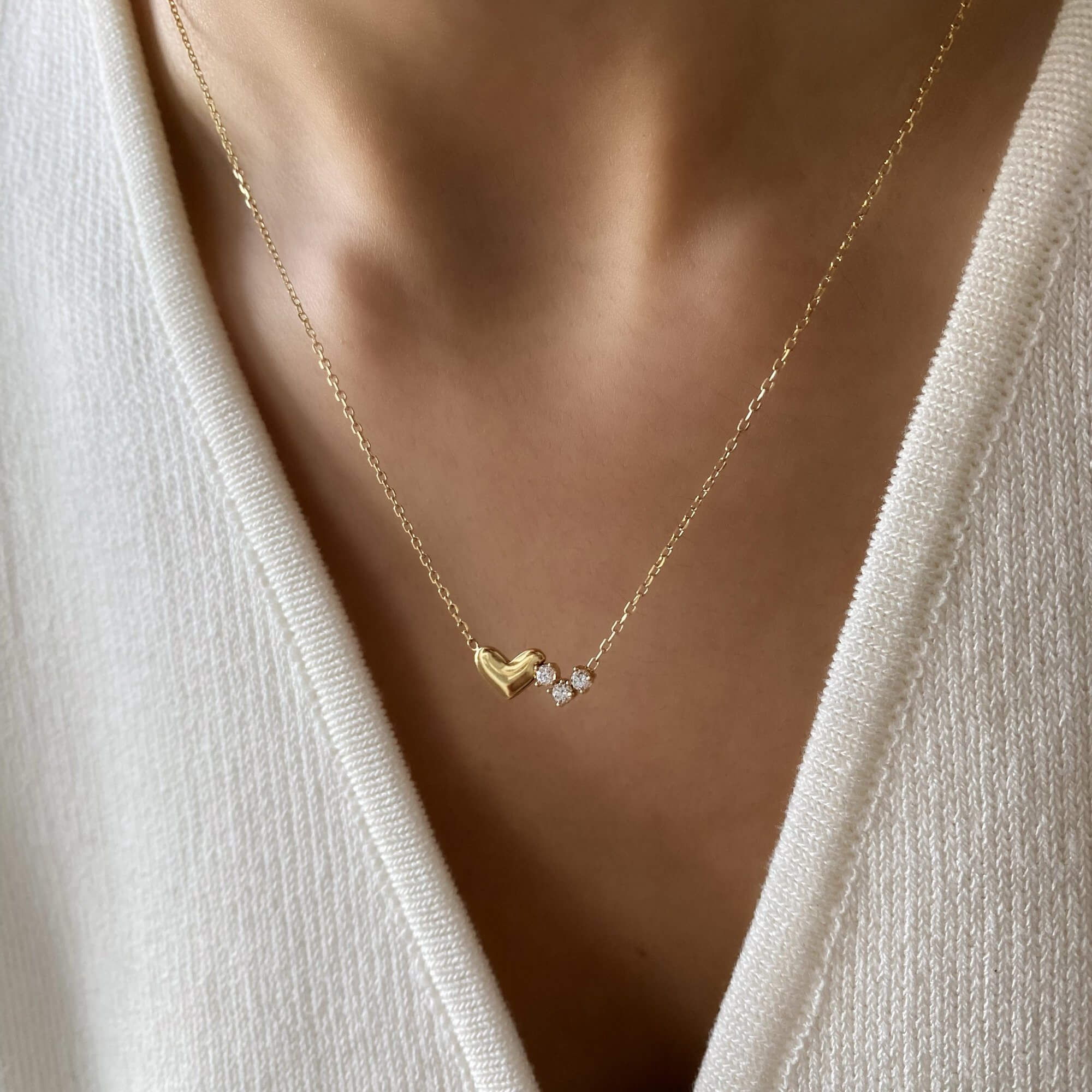 The KassyN double heart charm necklace by Kampy Designs, elegantly worn to showcase its timeless charm and stylish appeal.