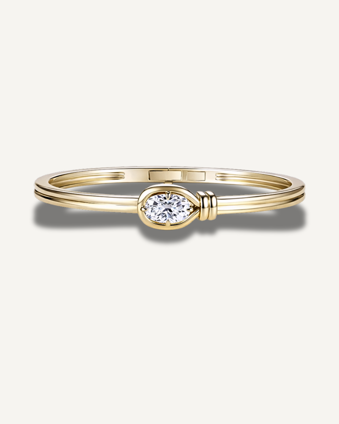 Elara elongated cushion cut moissanite knot bangle in 14K gold over 925 sterling silver featuring a bezel set 2ct center stone and sculptural double band design.