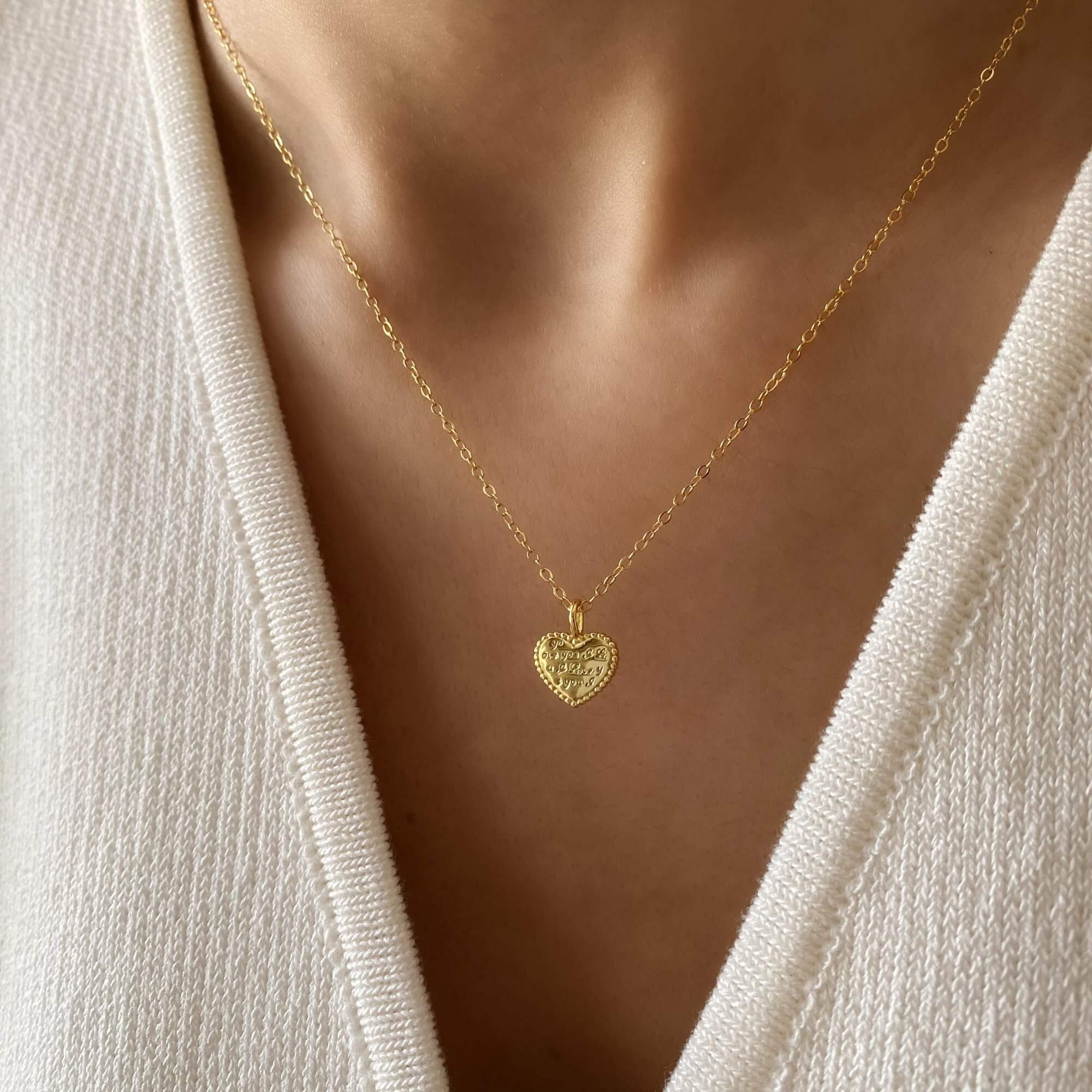 The KatreenN engraved heart necklace by Kampy Designs, worn to highlight its delicate heart pendant and sophisticated look.