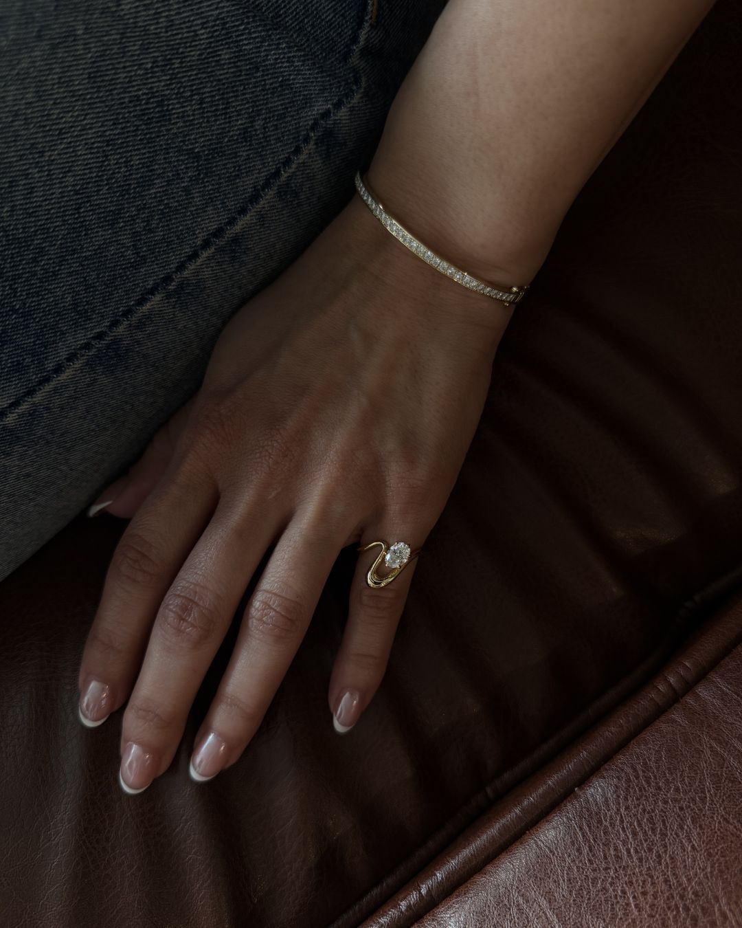 Oval moissanite pinky ring styled with a tennis bangle for an elevated everyday gold jewelry look