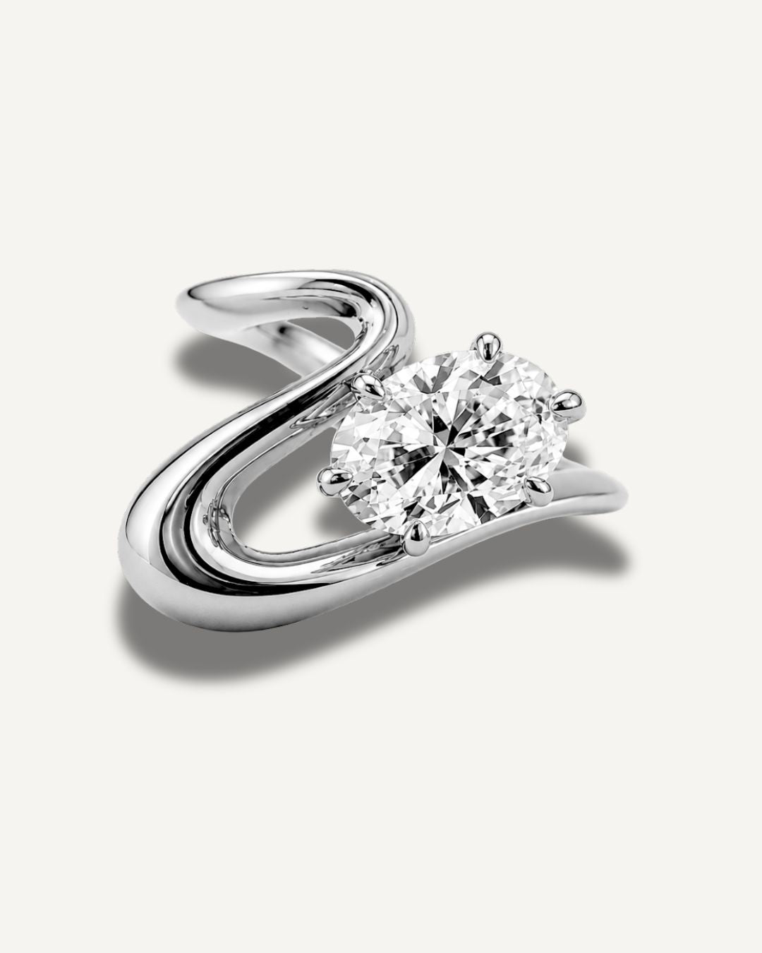 Silver wave band pinky ring with oval moissanite center stone in a clean front view on a neutral background