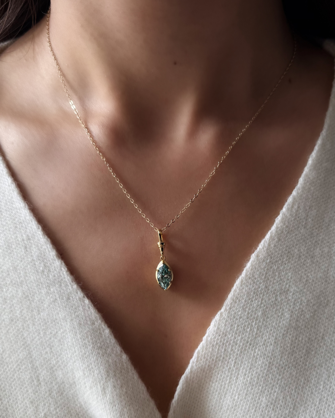 Green marquise-cut moissanite pendant necklace worn on model with gold chain in 925 sterling silver by Kampy.