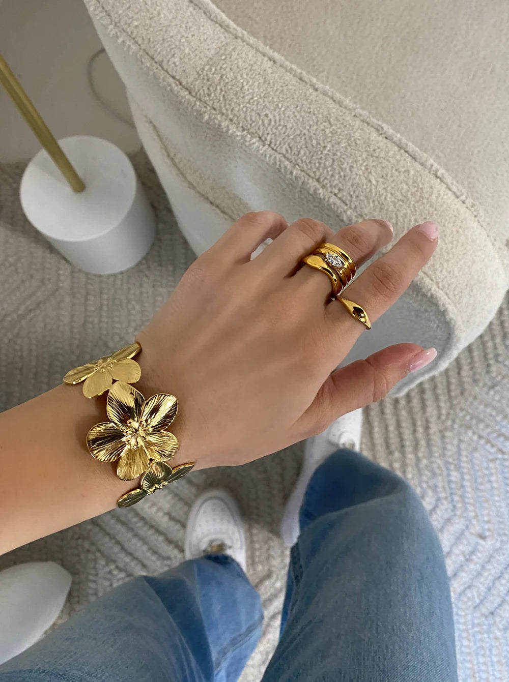 The KloraB hibiscus flower cuff bracelet by Kampy Designs, elegantly styled with complementary accessories for a chic floral-inspired look.