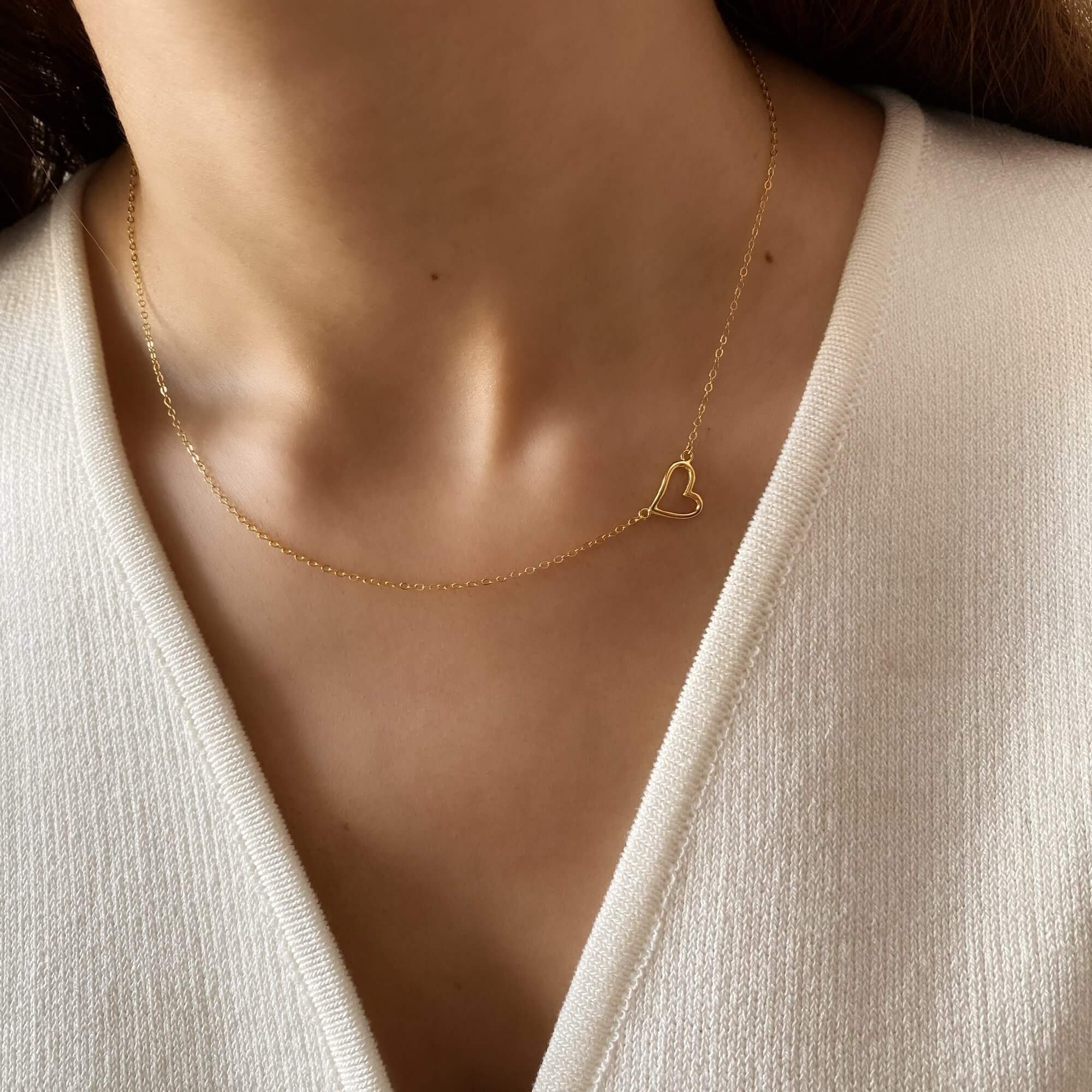 Close-up of the KieraN hollow heart charm pendant necklace by Kampy Designs, worn to showcase its elegant and minimalist appeal.