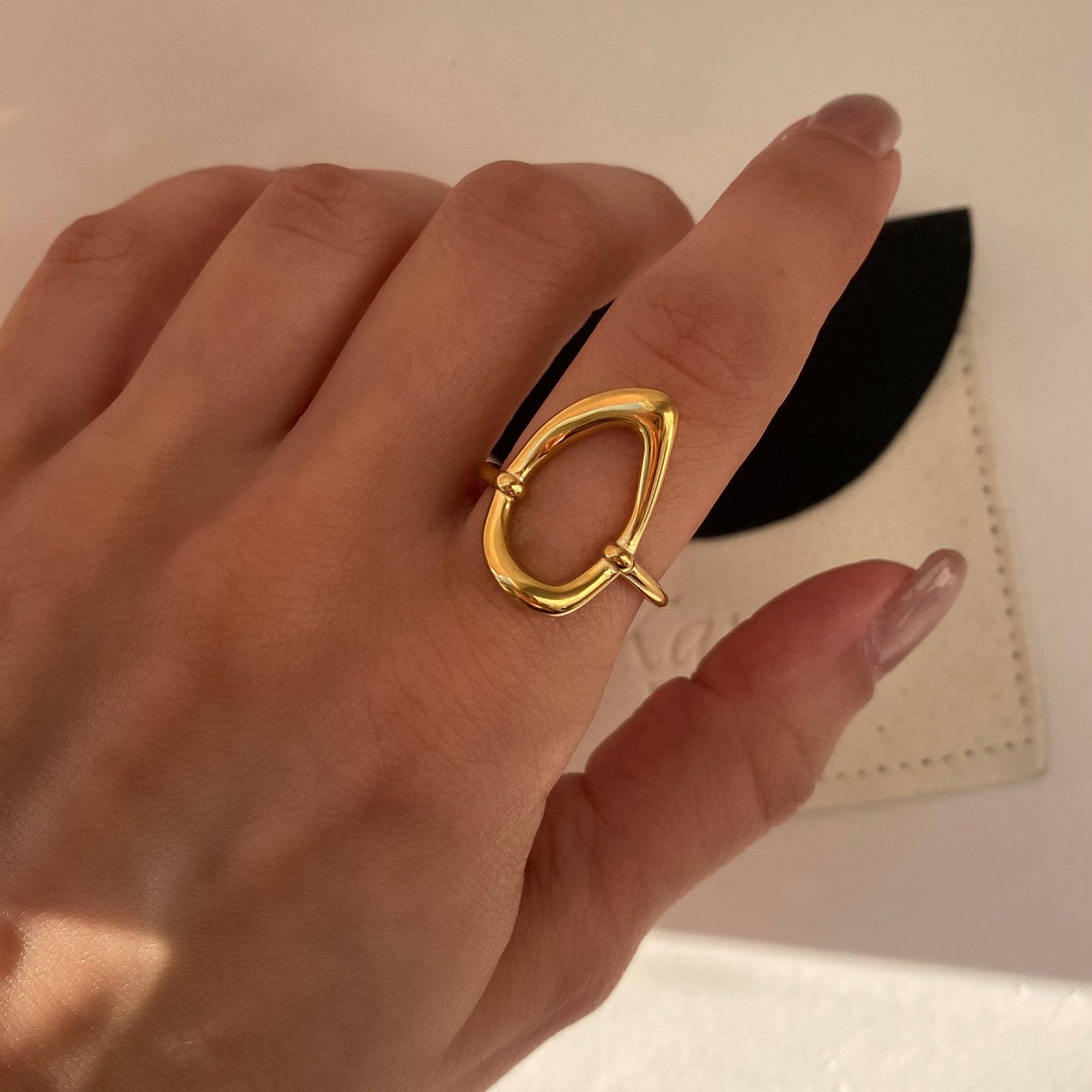 Close-up of KatyR hollow oval ring by Kampy Designs, worn on model's finger to highlight its minimal and modern cutout design.