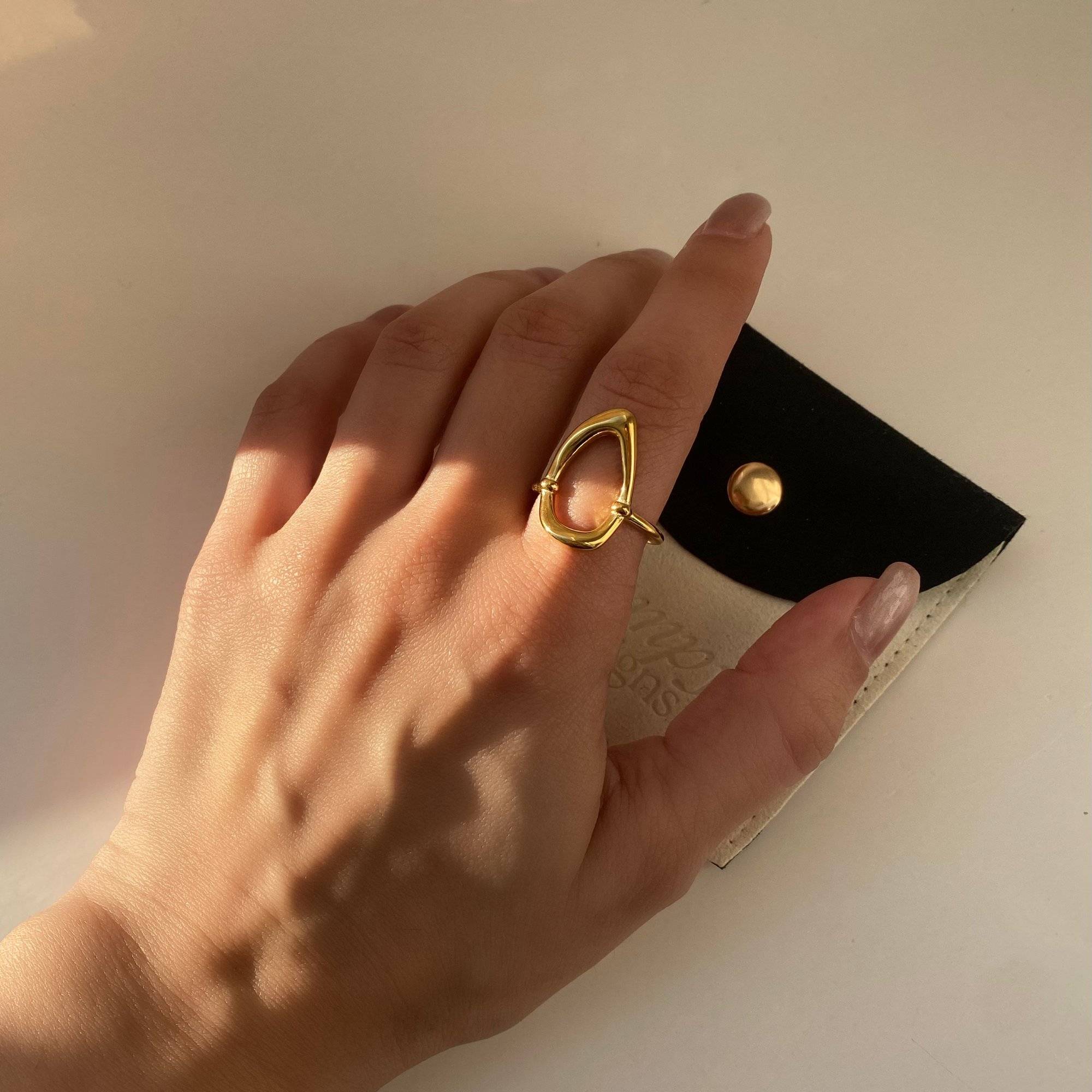 KatyR hollow oval ring by Kampy Designs, styled on model’s finger for a clean view of its open geometric centerpiece.
