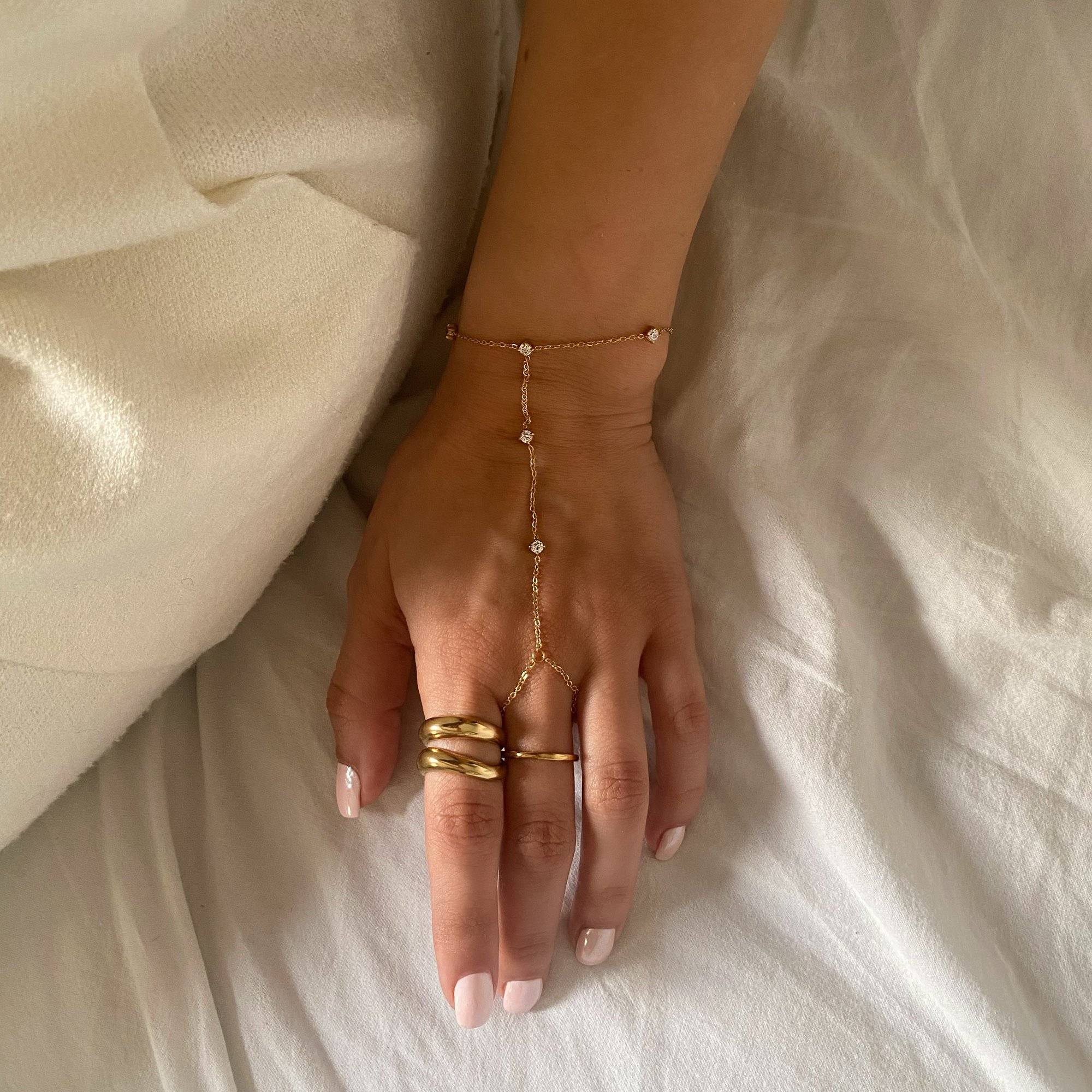 Angled styled shot of KatyR hollow oval ring by Kampy Designs, emphasizing the dimensional oval cutout and polished gold finish.