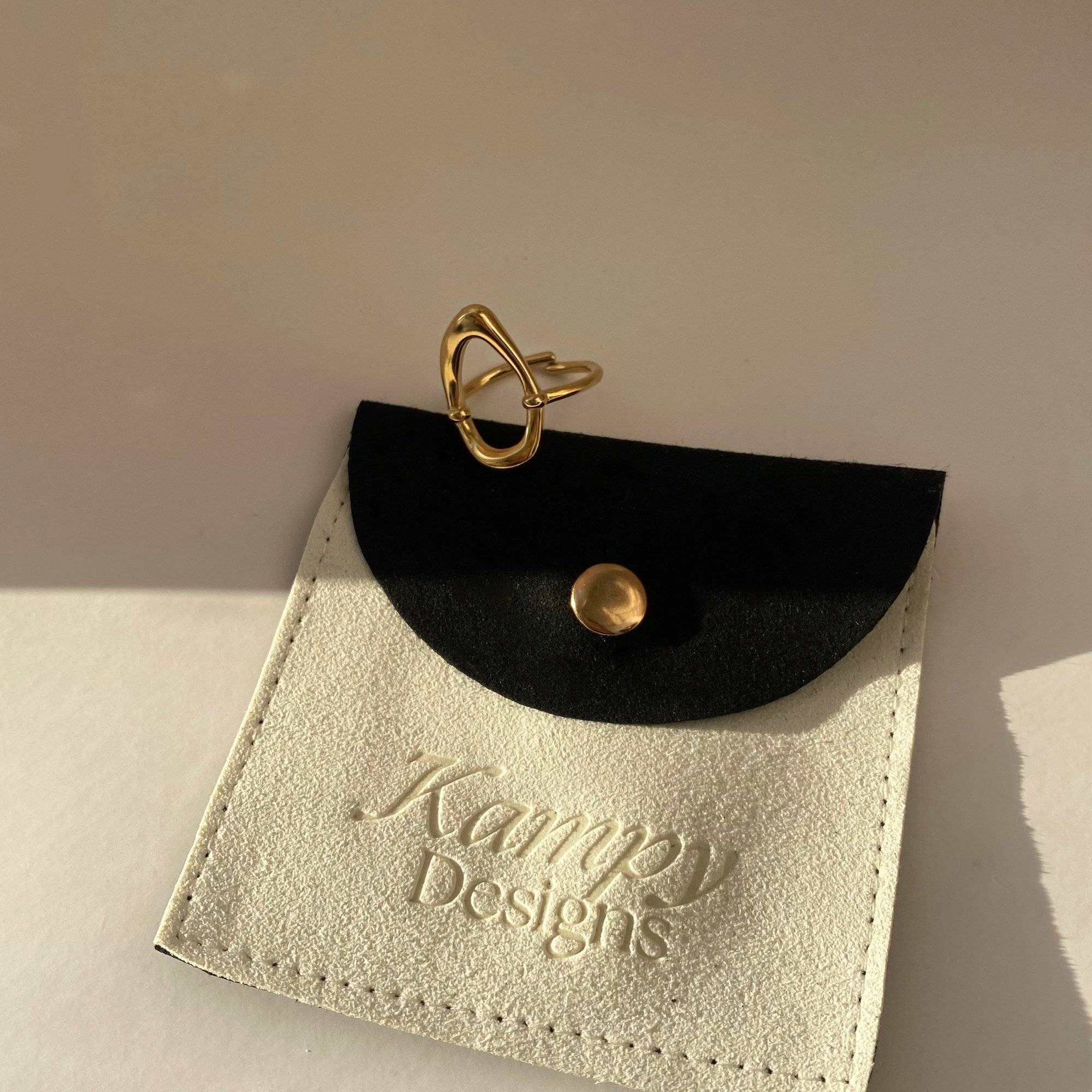 Model holding KatyR hollow oval ring by Kampy Designs, showcasing its sleek silhouette and open center design.