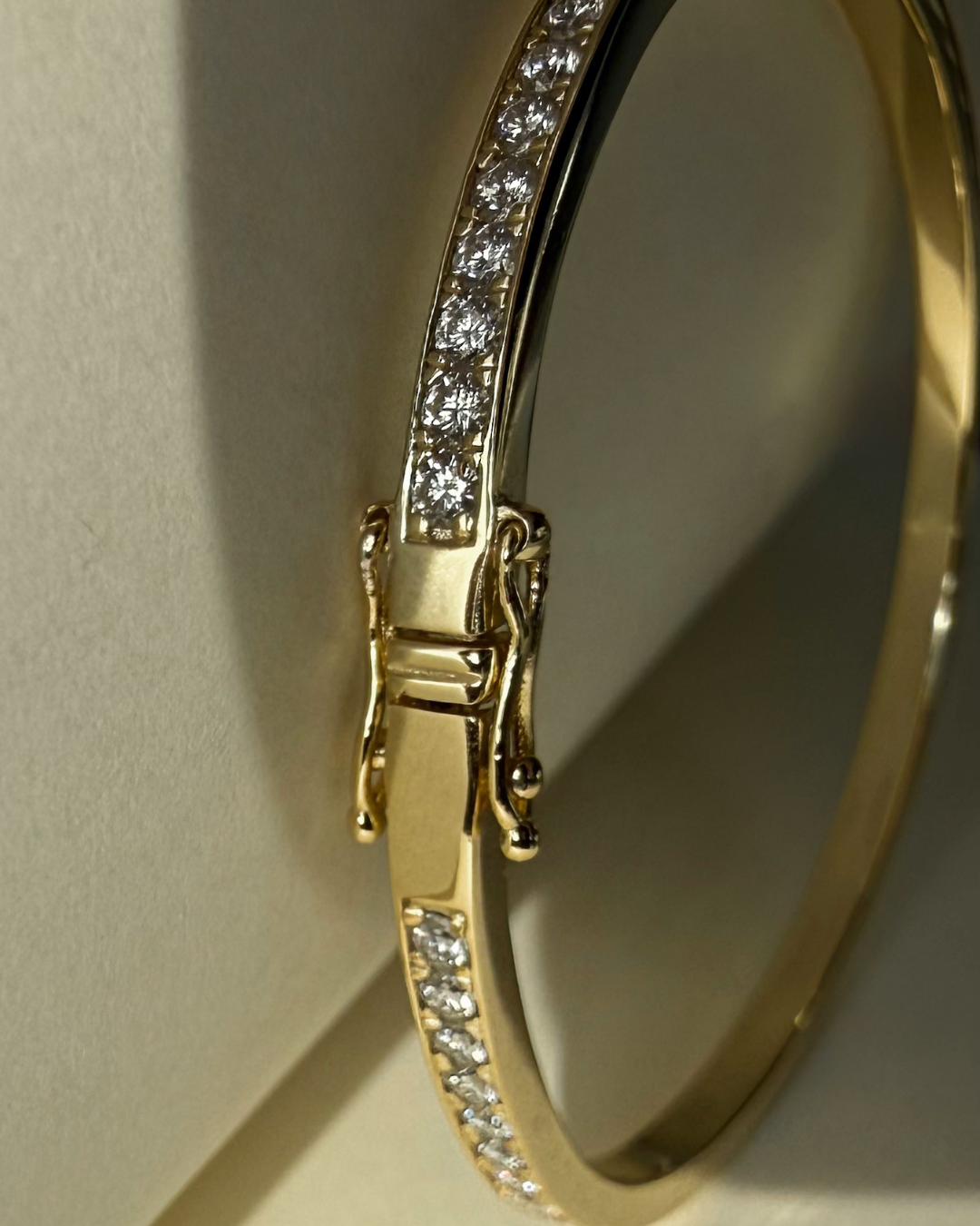Detail view of Lara moissanite eternity bangle clasp in 14K gold over sterling silver with reinforced locking mechanism.