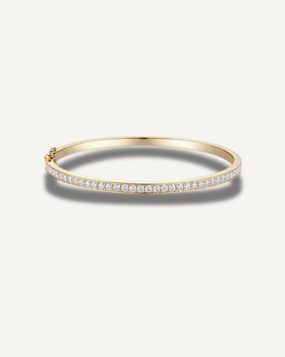 Lara 2mm moissanite tennis eternity bangle in 14K gold over 925 sterling silver featuring a slim 3mm pavé design and secure clasp closure.