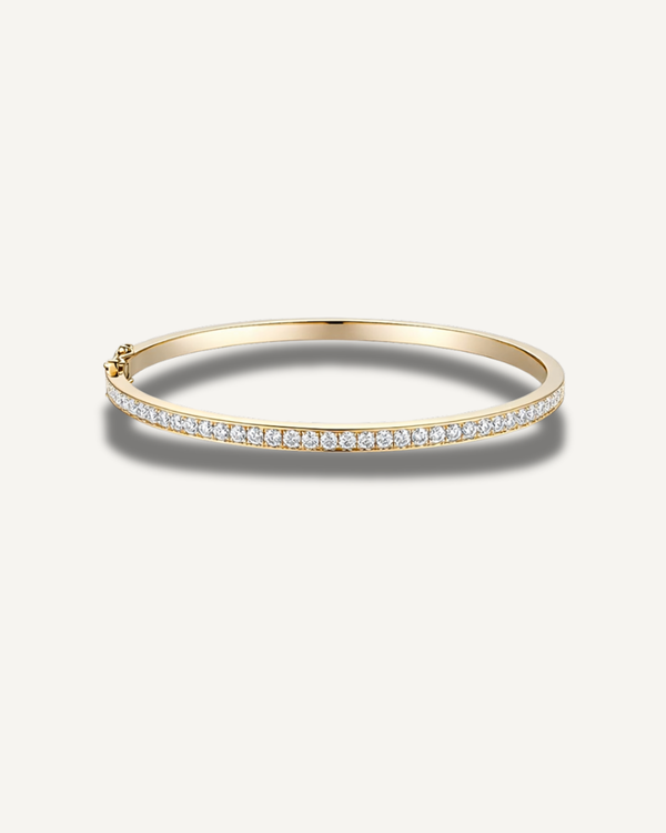 Lara 2mm moissanite tennis eternity bangle in 14K gold over 925 sterling silver featuring a slim 3mm pavé design and secure clasp closure.