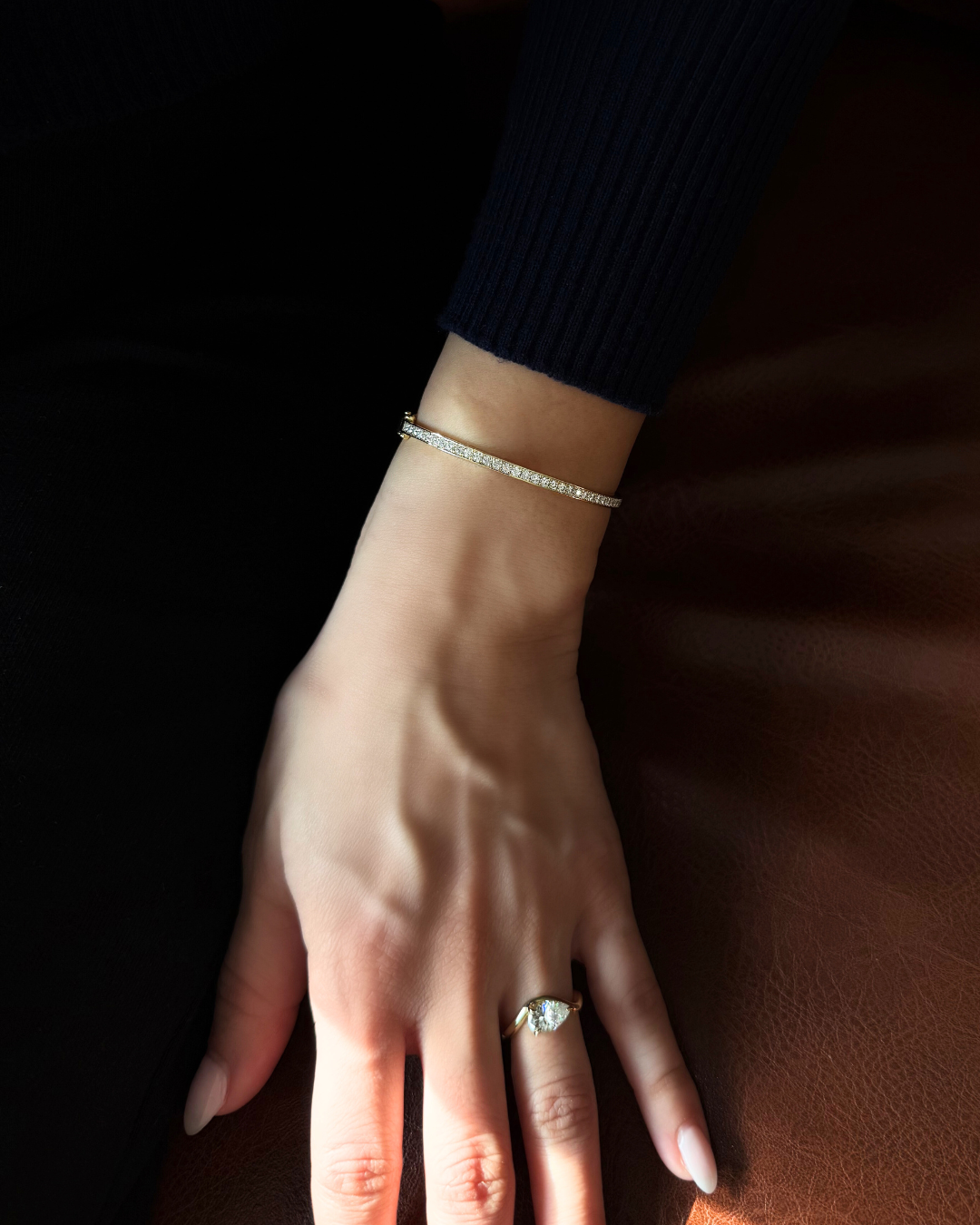 Close-up of Lara slim moissanite eternity bangle in 14K gold over sterling silver showing continuous pavé stones and polished finish.