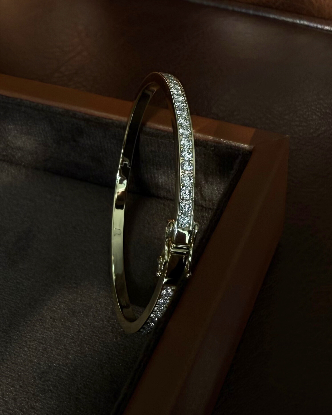 Angled view of Lara slim moissanite tennis eternity bangle featuring 2mm stones, 3mm band thickness, and refined stacking profile.