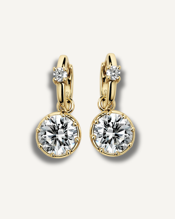 2ct round solitaire drop huggie earrings in gold finish on neutral background, Kampy Designs