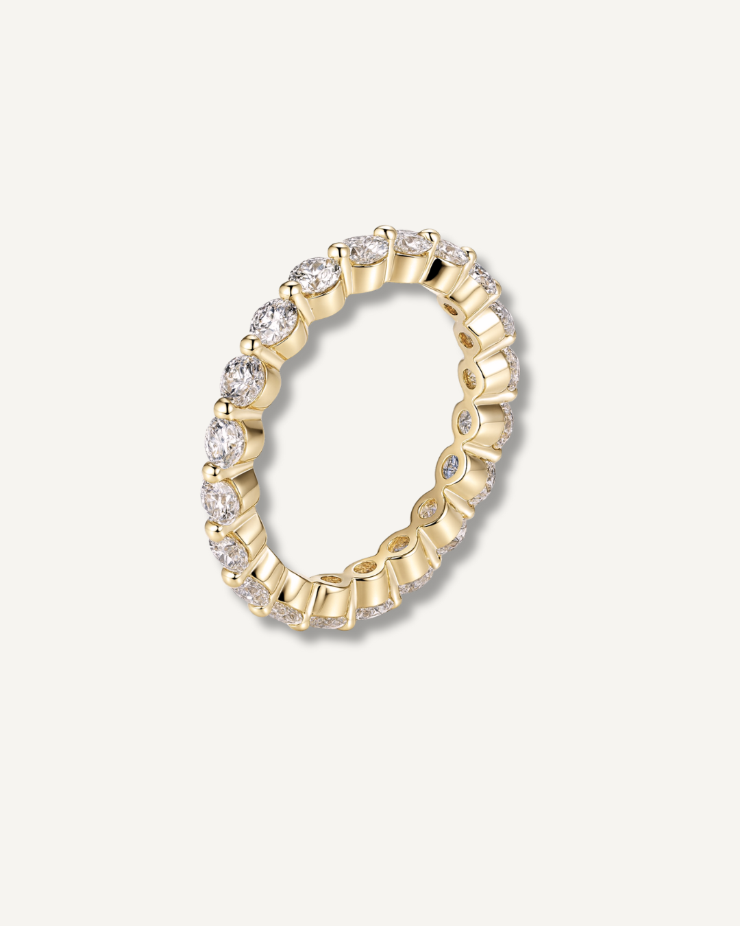 Round moissanite eternity band in gold finish on neutral background, Kampy Designs