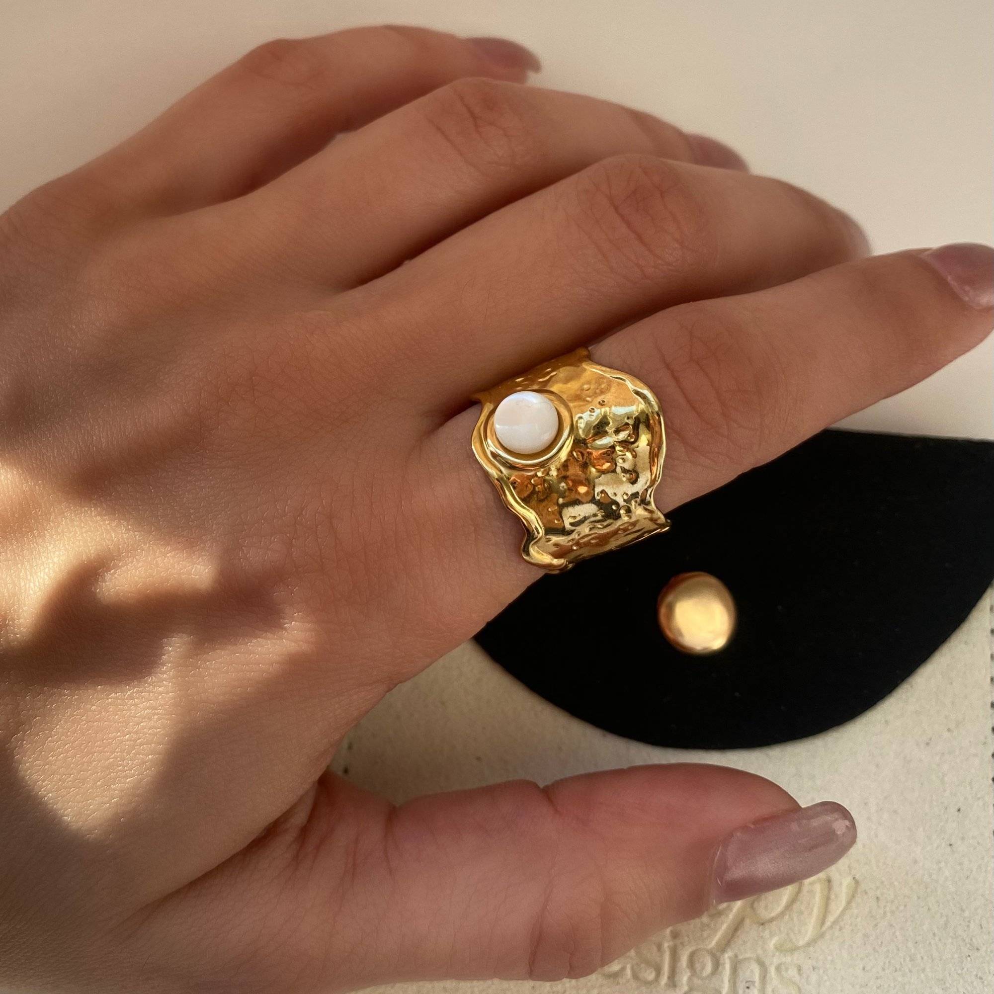 Flat lay of Kennar opal hammered ring by Kampy Designs, presented on a branded pouch for a premium, gift-ready appearance.