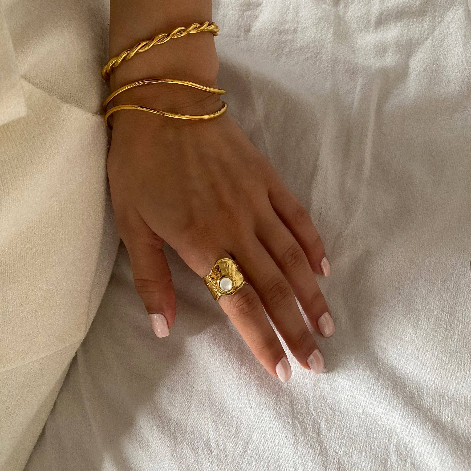 Kennar opal hammered ring by Kampy Designs, styled on model’s hand to highlight the bold hammered texture and luminous opal stone.