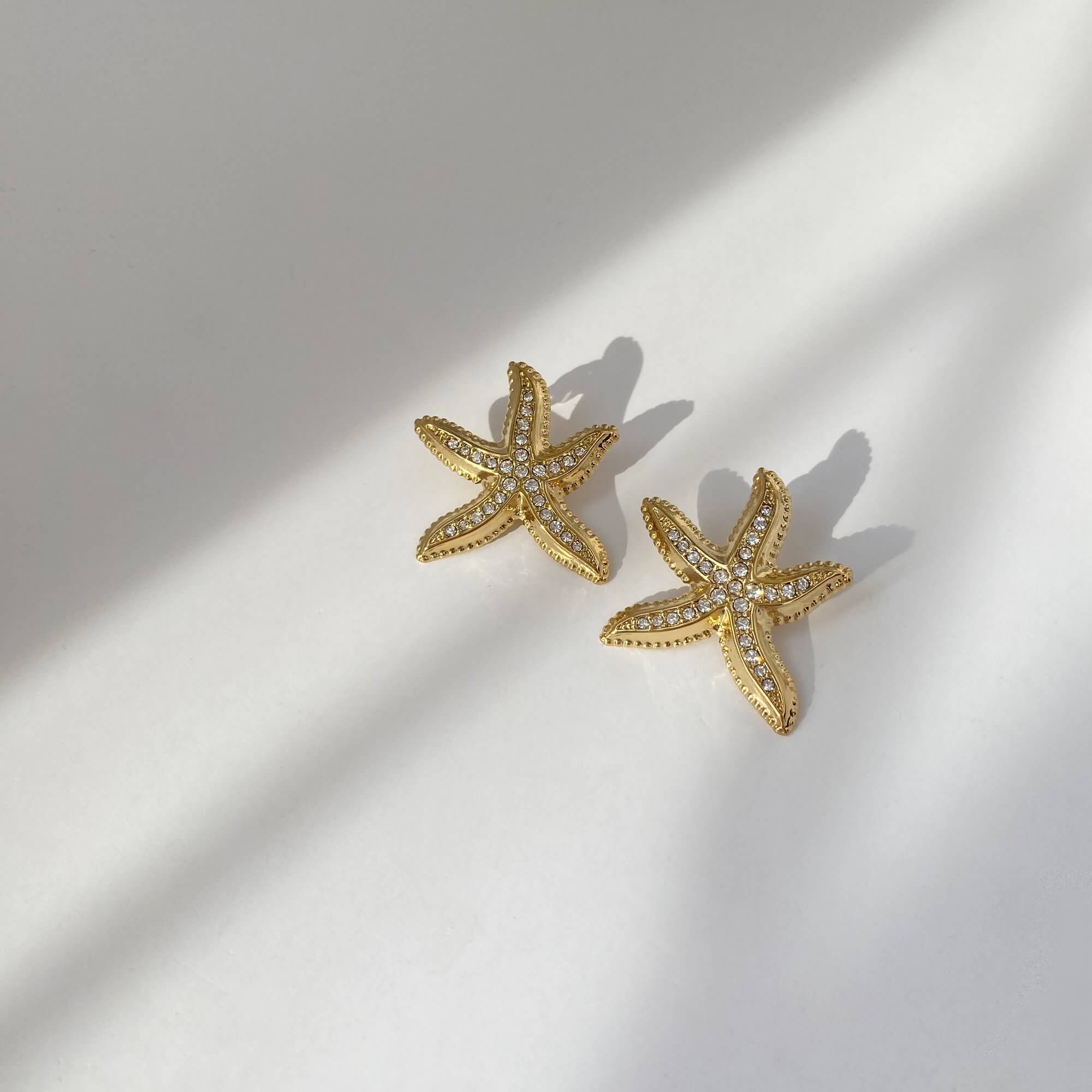 Flat lay of KariyaE pavé starfish statement earrings by Kampy Designs, capturing the symmetry and sparkle of the seaside-inspired design.