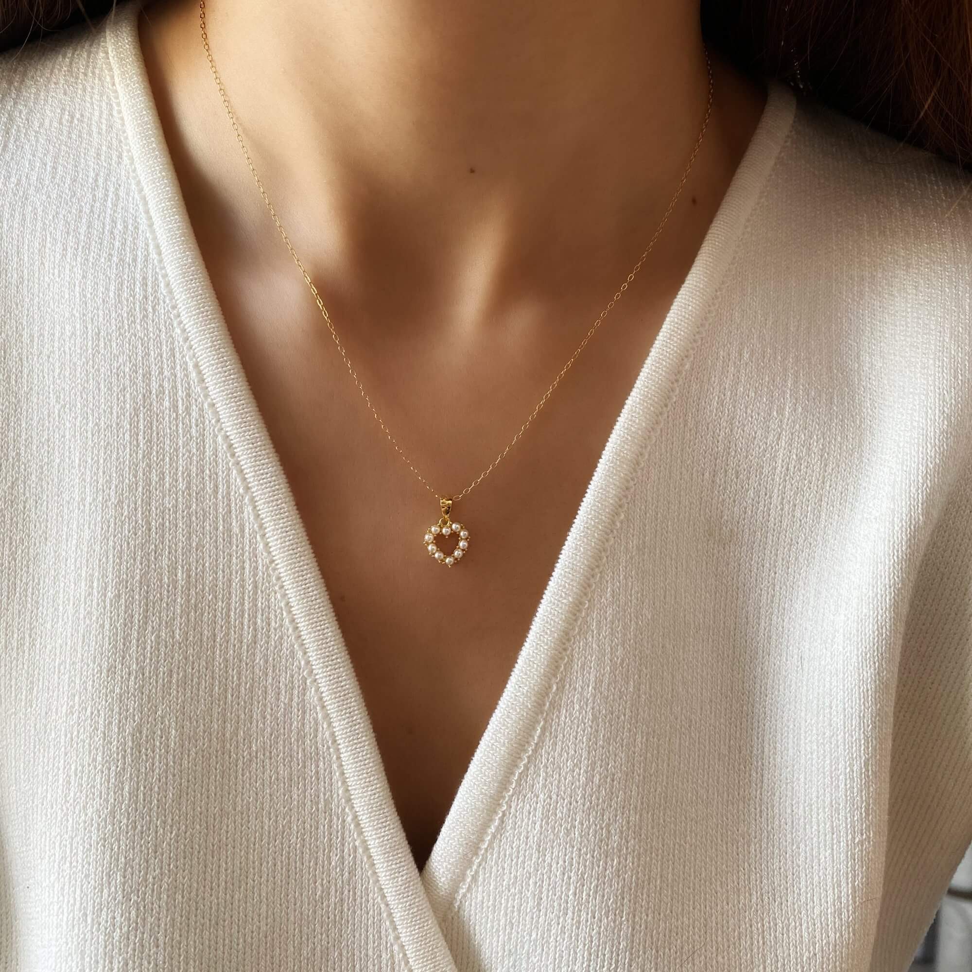 Close-up of the KenaN pearl heart pendant necklace by Kampy Designs, highlighting its fine detailing and lustrous pearl centerpiece.